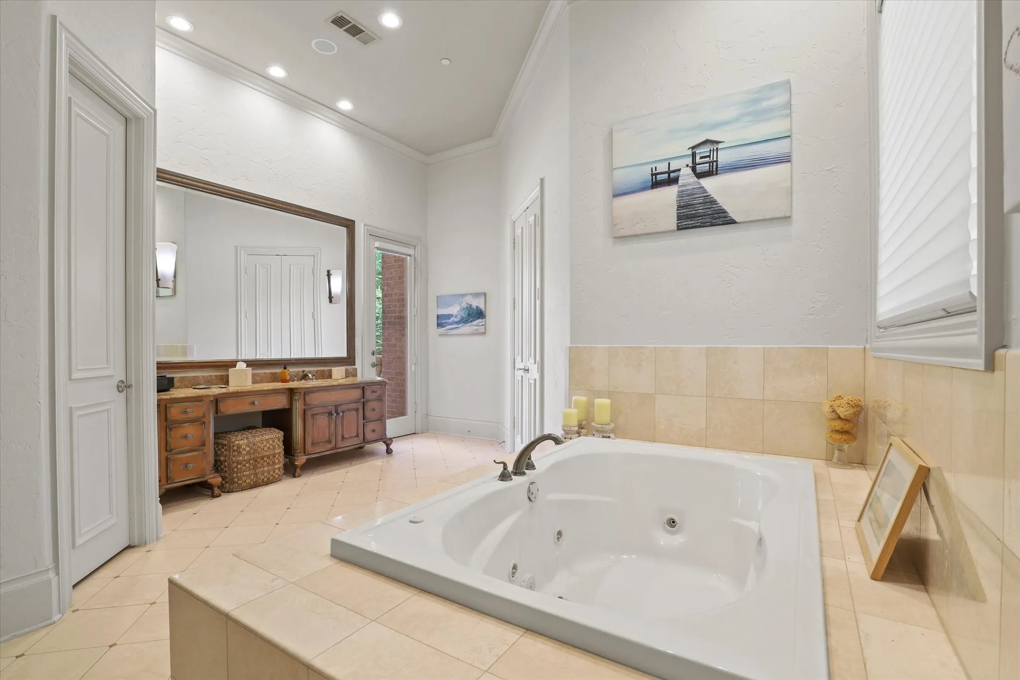 One side of the Primary Bath.  There is a large jetted Tub, his and hers water closets and a large central shower that can be accessed from either side of the bath.