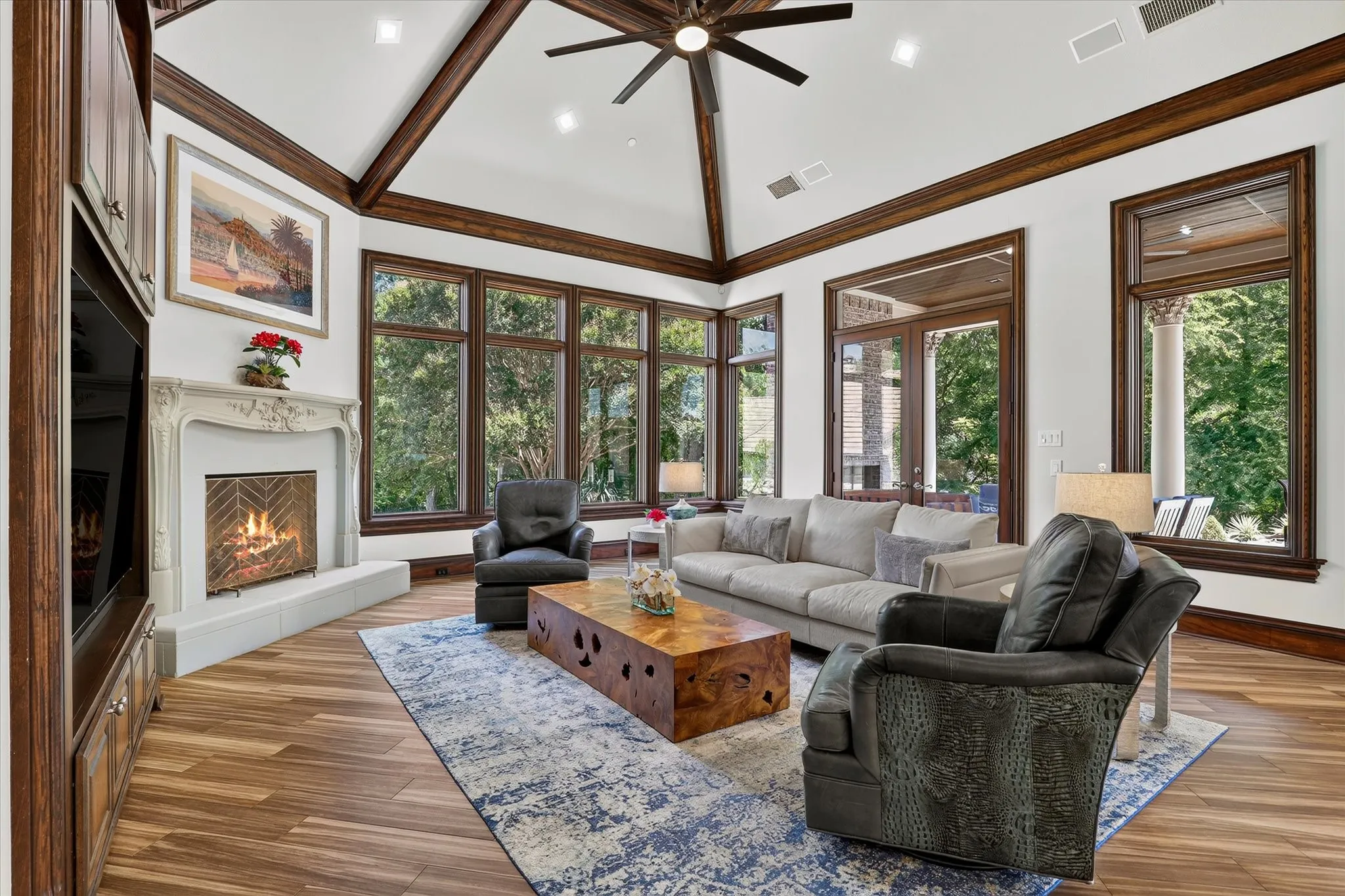 The Family Room features windows all around for gorgeous views and a warming fireplace.