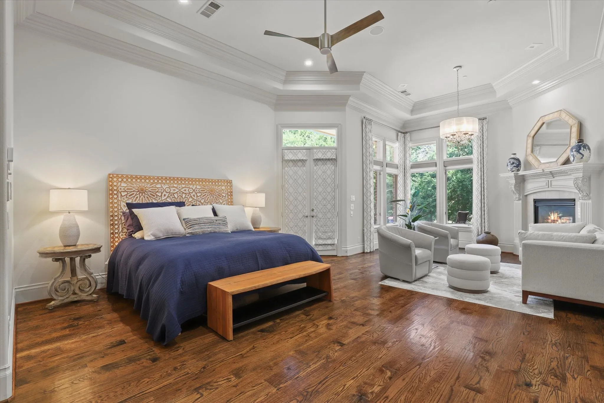 The Primary Bedroom is lovely with wood floors, a coffee bar area (not shown), a sitting area and fireplace and direct access to the pool and spa.