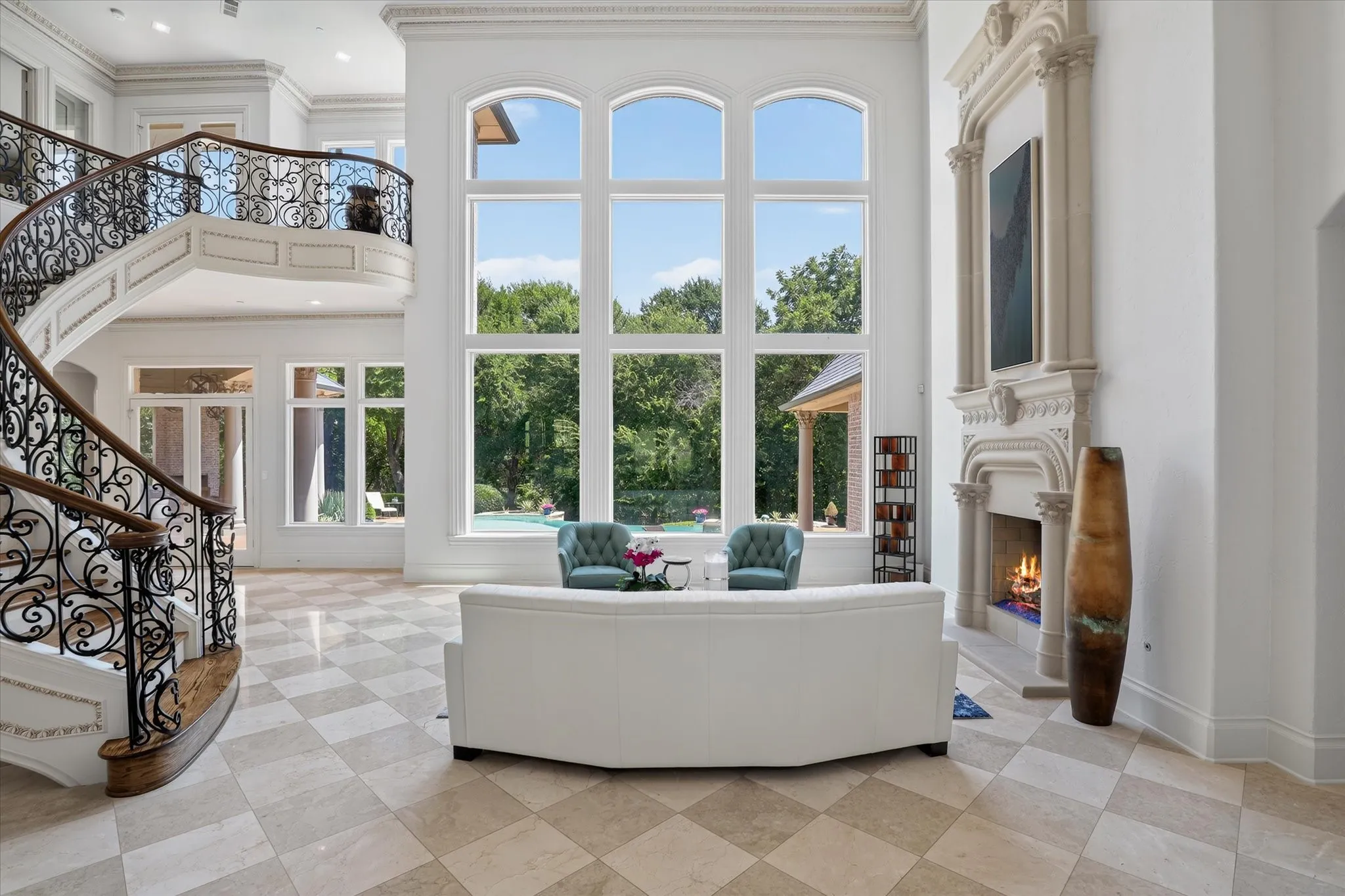 Step inside and the views go on and on.  The floating staircase adds beauty while the treed creek view behind the home beckons.