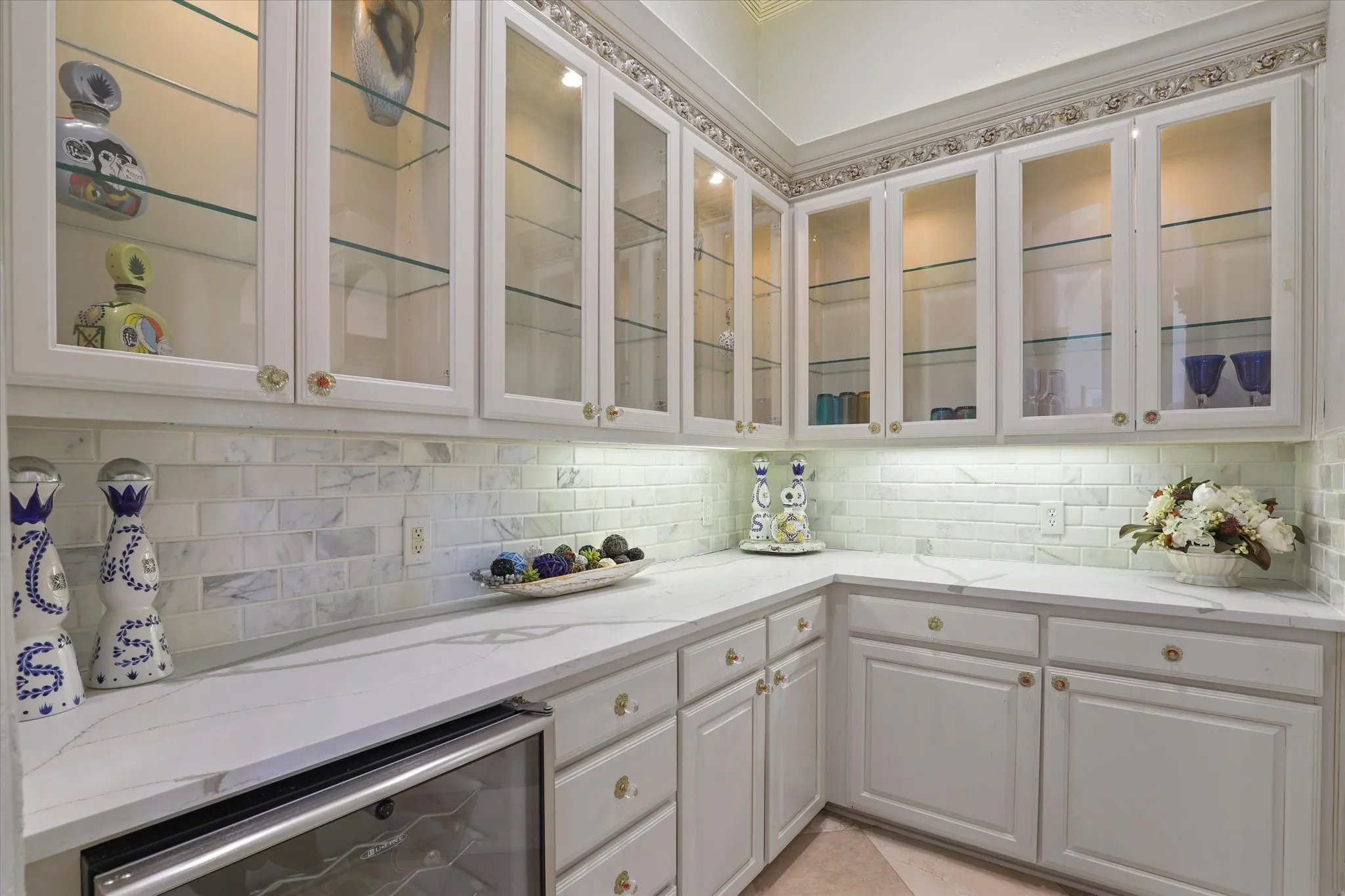The dry bar is just across from the wine storage room and offers abundant cabinetry and storage.