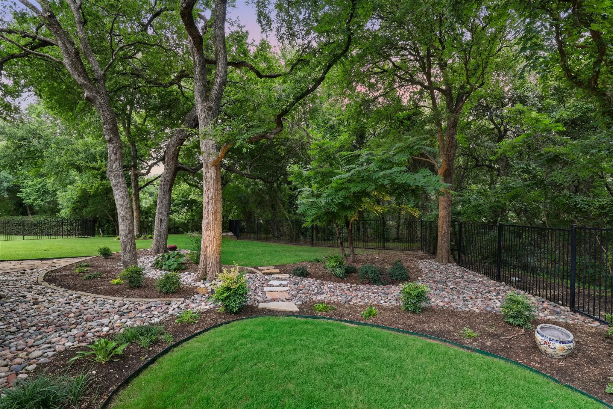 Backing to a creek provides the perfect backdrop for enjoyable entertaining or lounging in  your back yard.