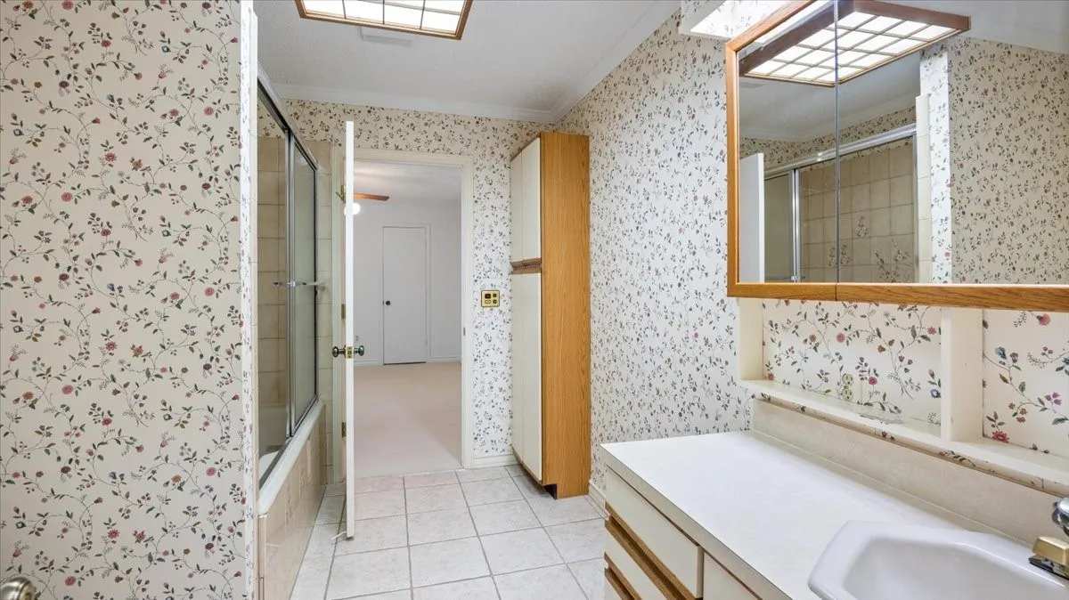 Second bath with jetted tub, door to the additional bedroom and a door to the hallway.