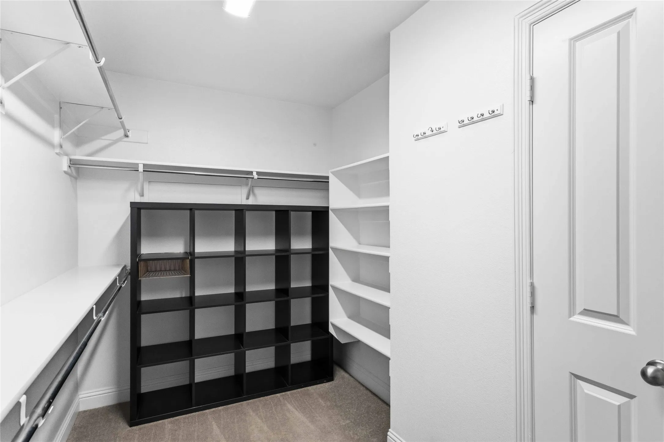 Integrated shelving units, multiple clothing rods, and wall-mounted hooks