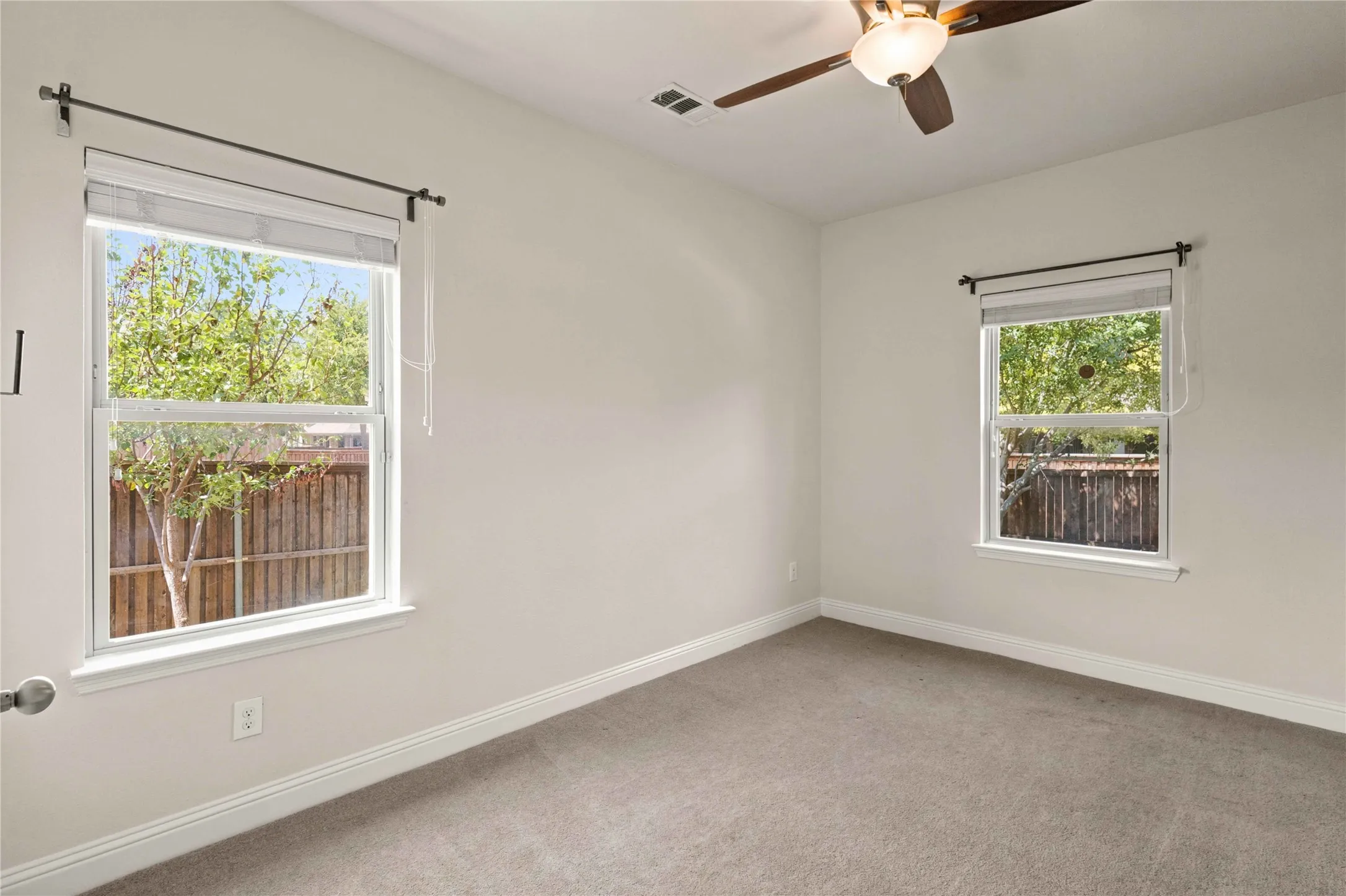 Neutral-toned walls complement plush carpeting