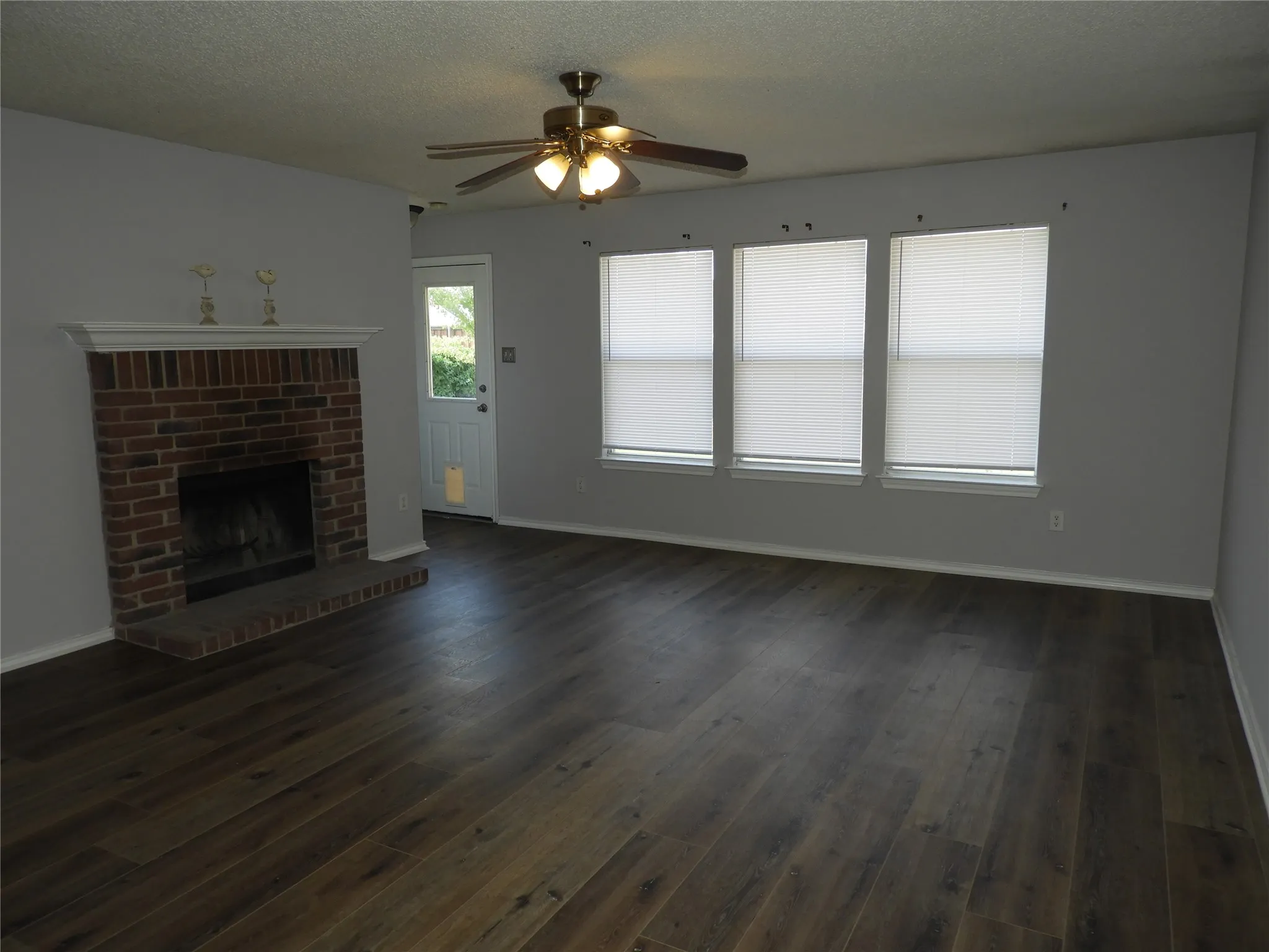 Living room with fireplace and ceiling fan