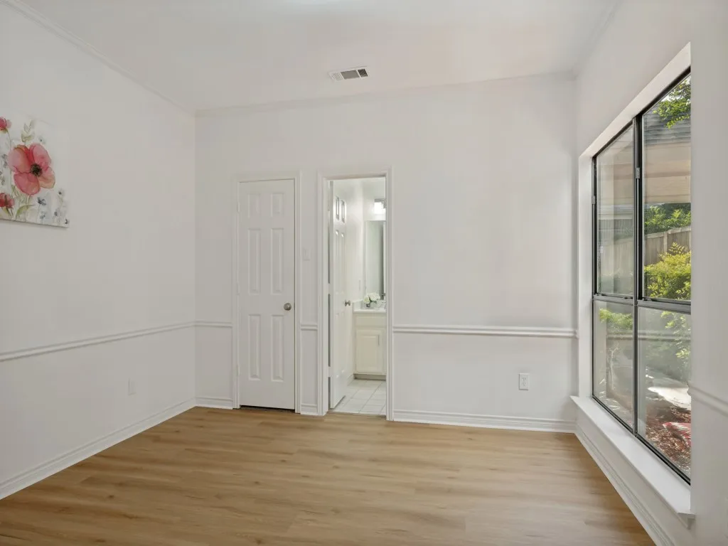 Bedroom with en-suite full bath overlooking courtyard.
