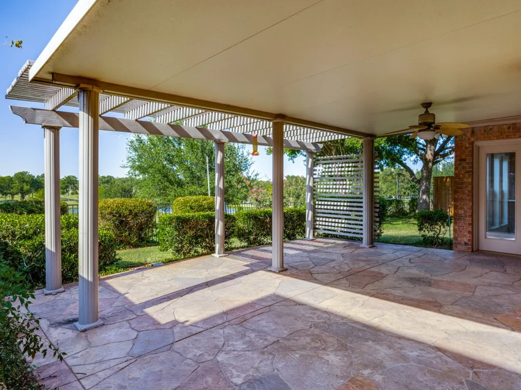 Relax on this expanded back covered patio overlooking the golf course and pond water feature.