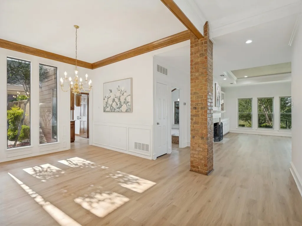 Welcome Home! Gorgeous dining area with view of private terrace, brick beam adds architectural interest as well as wainscotting and crown molding in dining area.