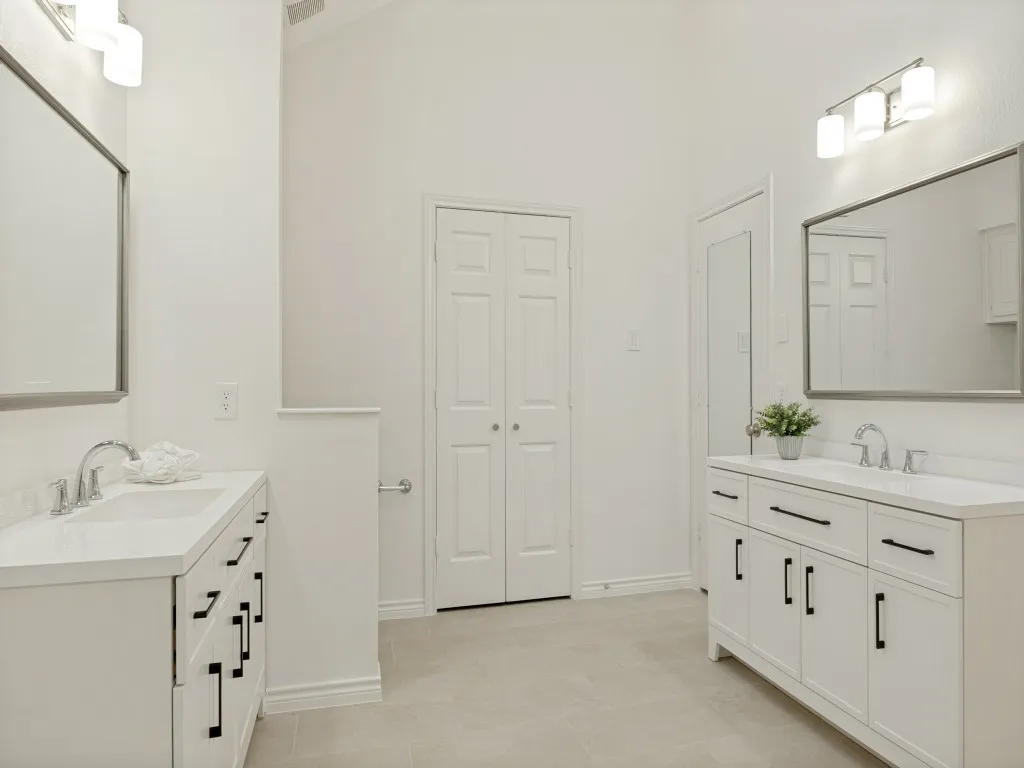 Updated Primary Suite with his-and-her vanities and walk-in-closets.