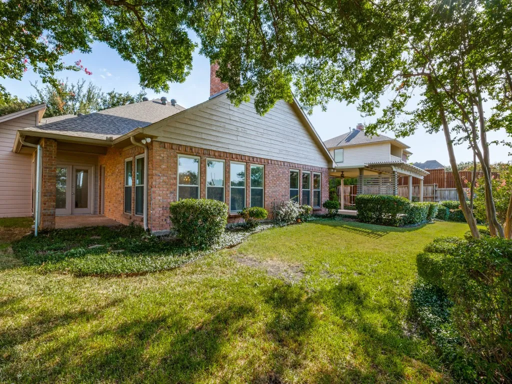 View of the back of the home, see the covered porch off the primary suite.
