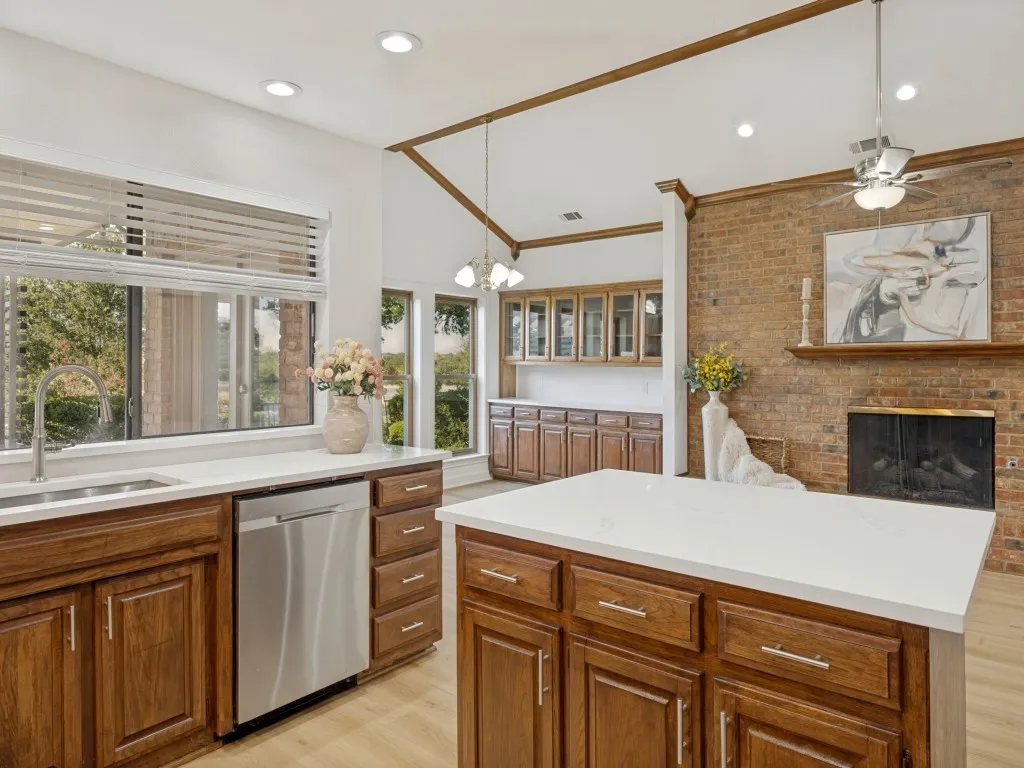 Home is great for entertaining, kitchen island, windows with view to golf course, brick fireplace, built in hutch, recessed lighting, wonderful flow.