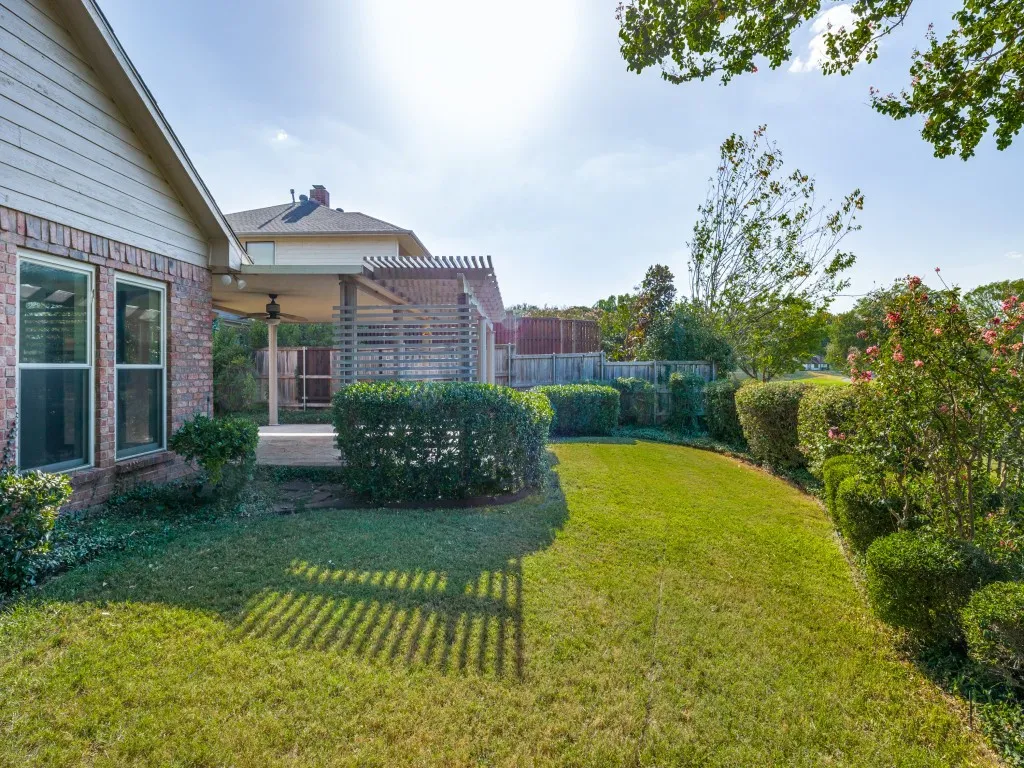 Fresh grass, lush landscaping, sprinkler system.