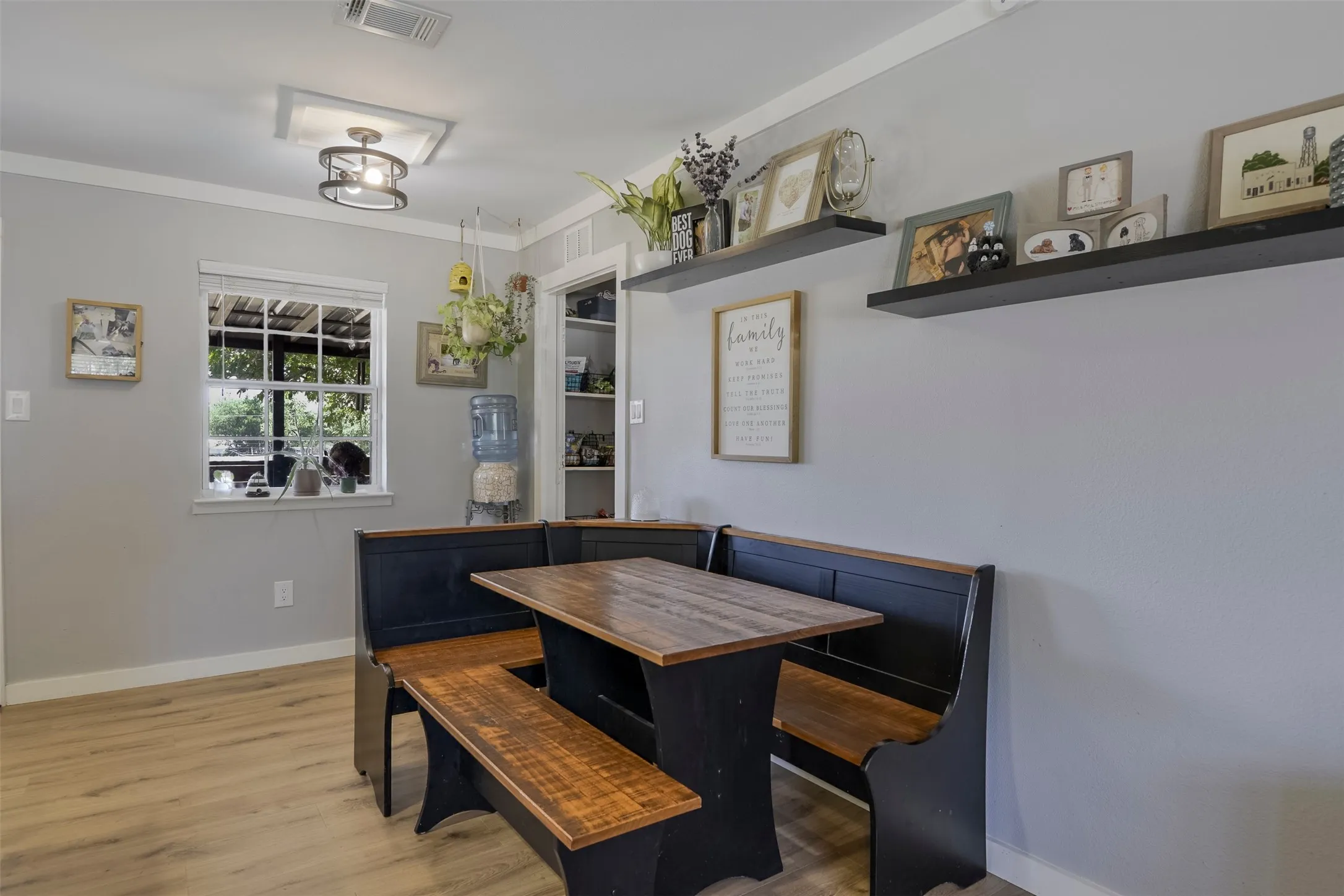 Light wood-finish flooring, white trim, and light gray walls