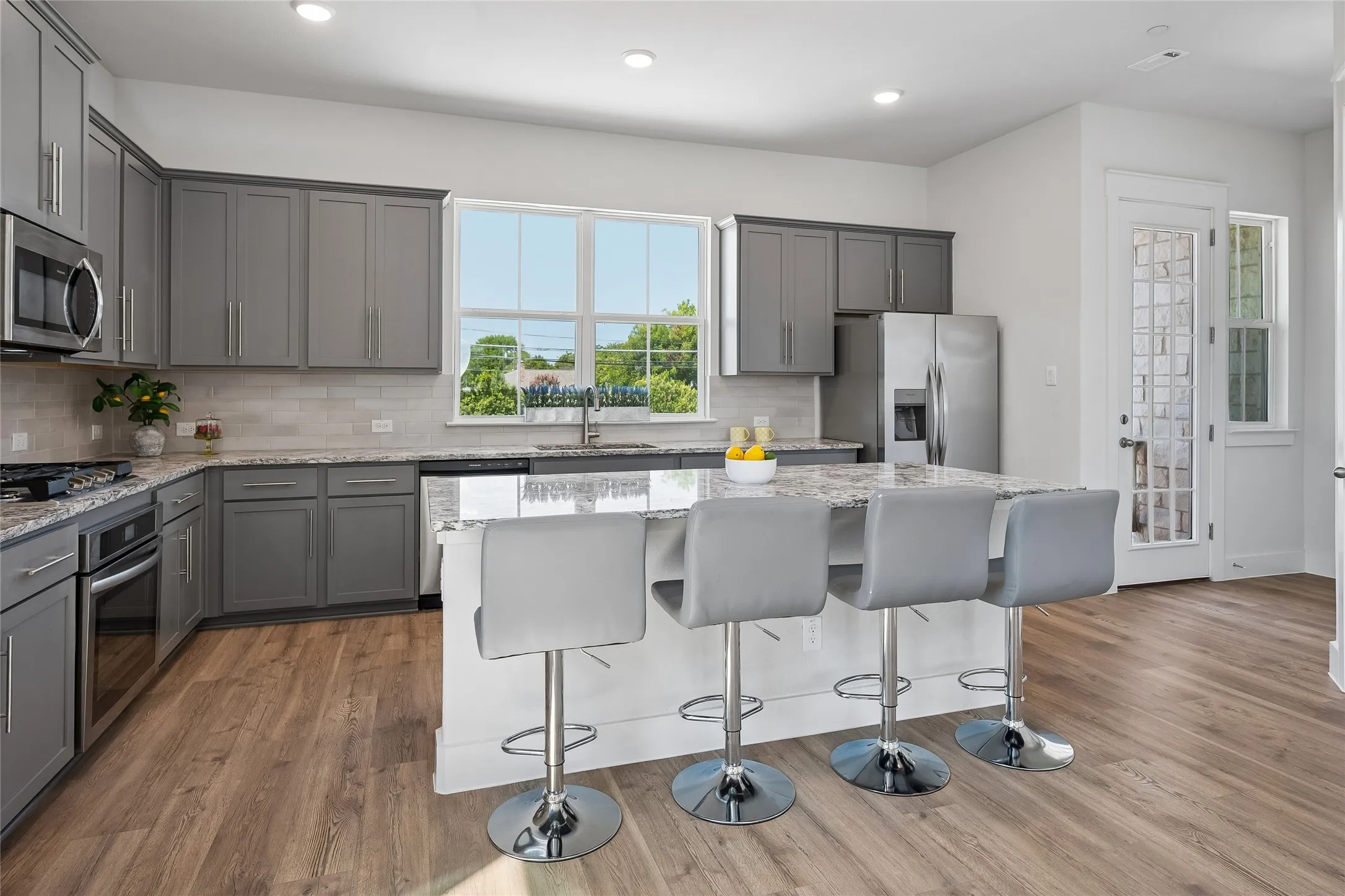 Large work island with seating. Door to balcony.