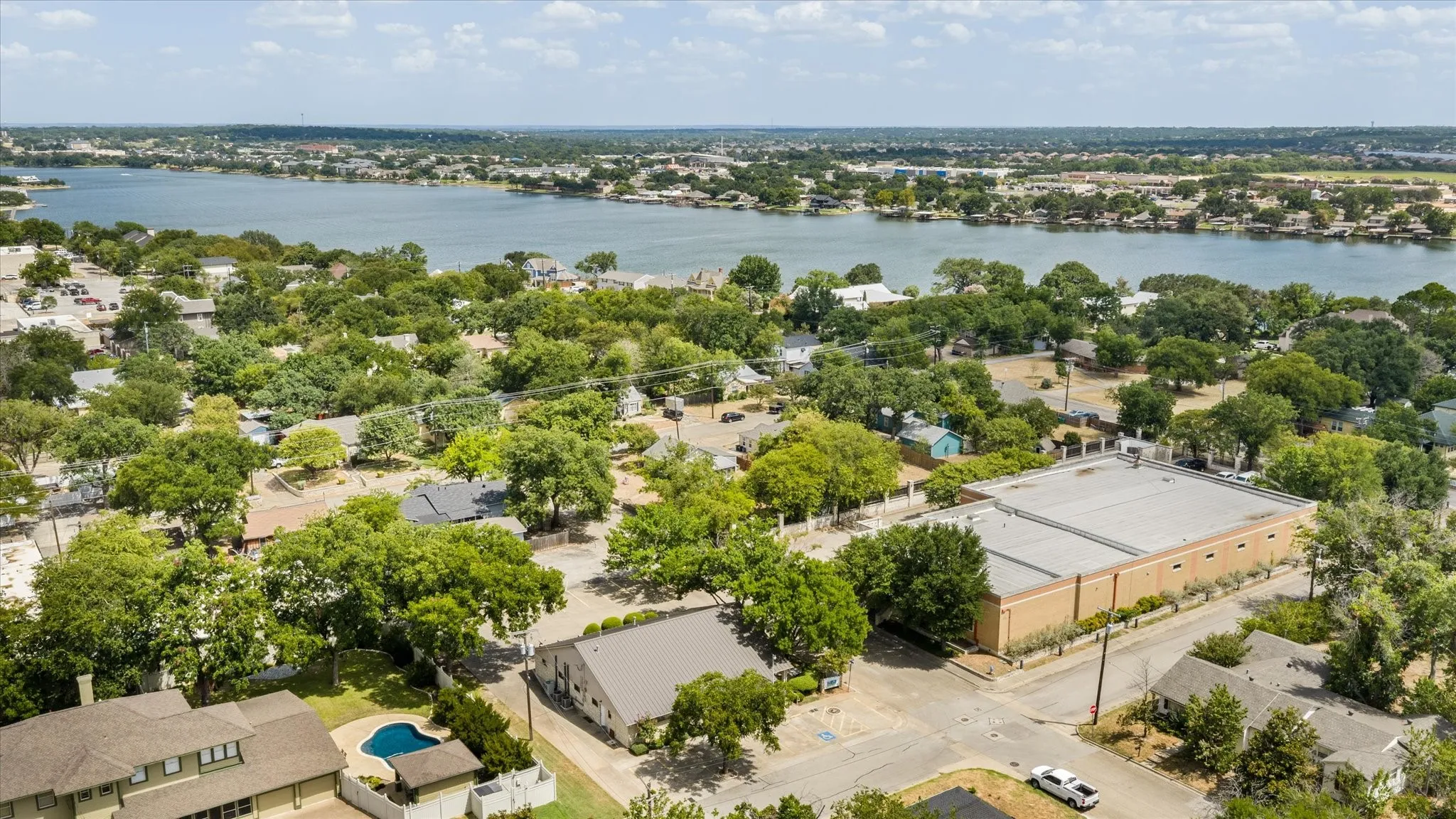 Expansive waterfront scenery, mature trees throughout the neighborhood, and an in-ground swimming pool