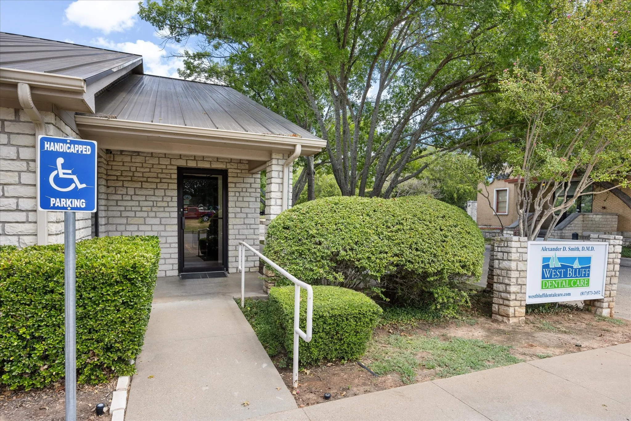 Stone brick exterior with a metal roof and covered entry