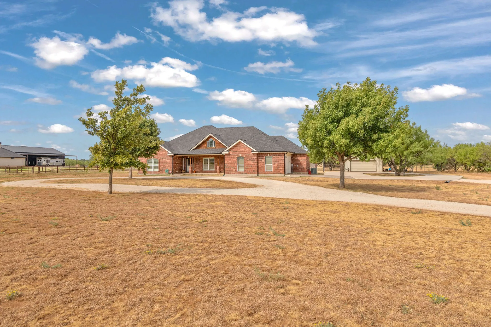 Plenty of parking with circle drive at front of home plus to the side leading to shop and two car side entry garage.
