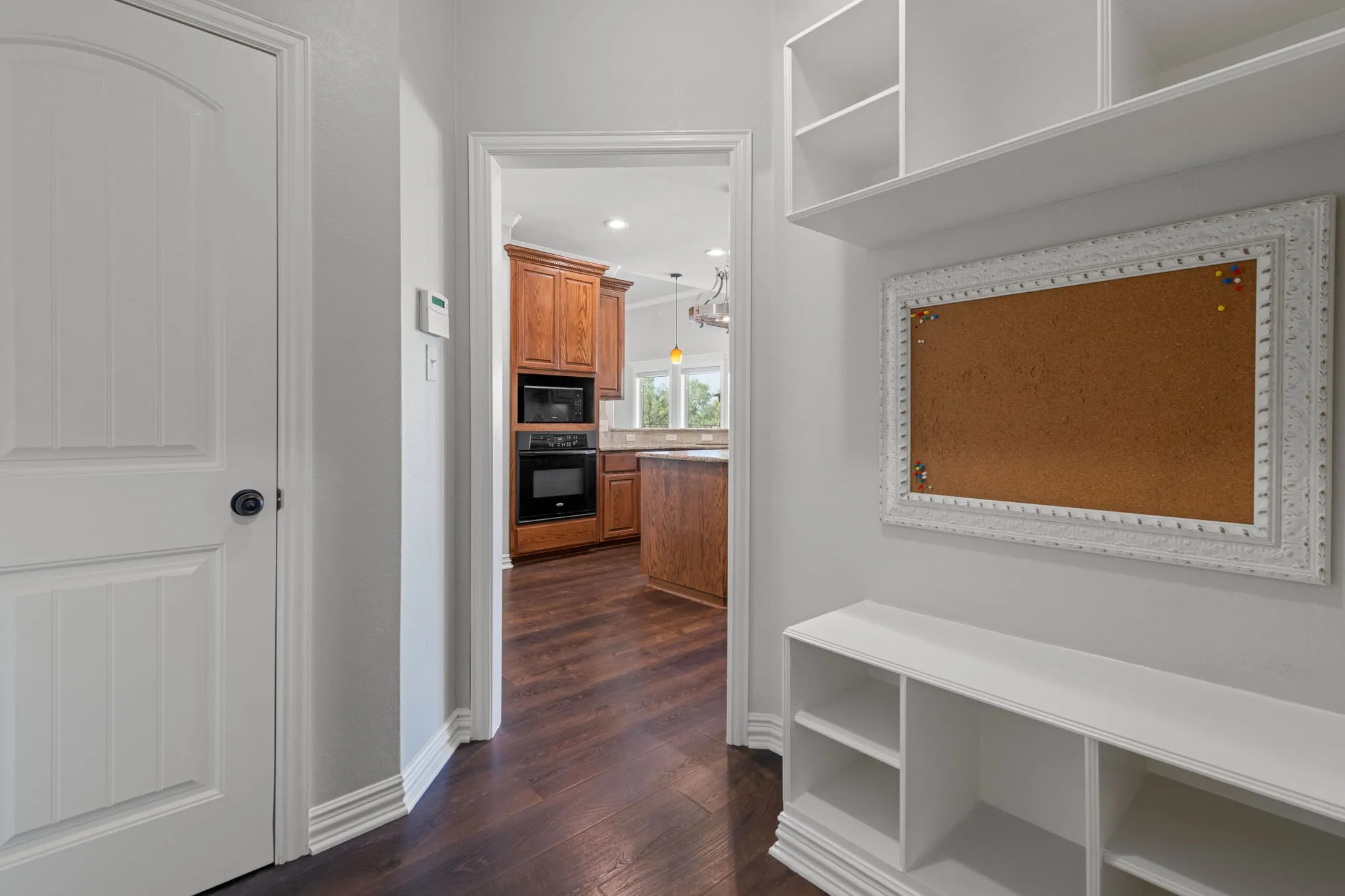 Built-in shelving with storage cubbies and coat closet.