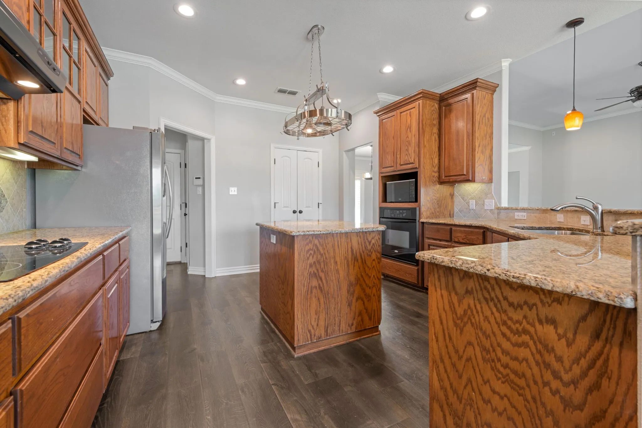 Kitchen featuring recessed lighting and a center island with a granite countertop.  Double doors lead to a walk in pantry.