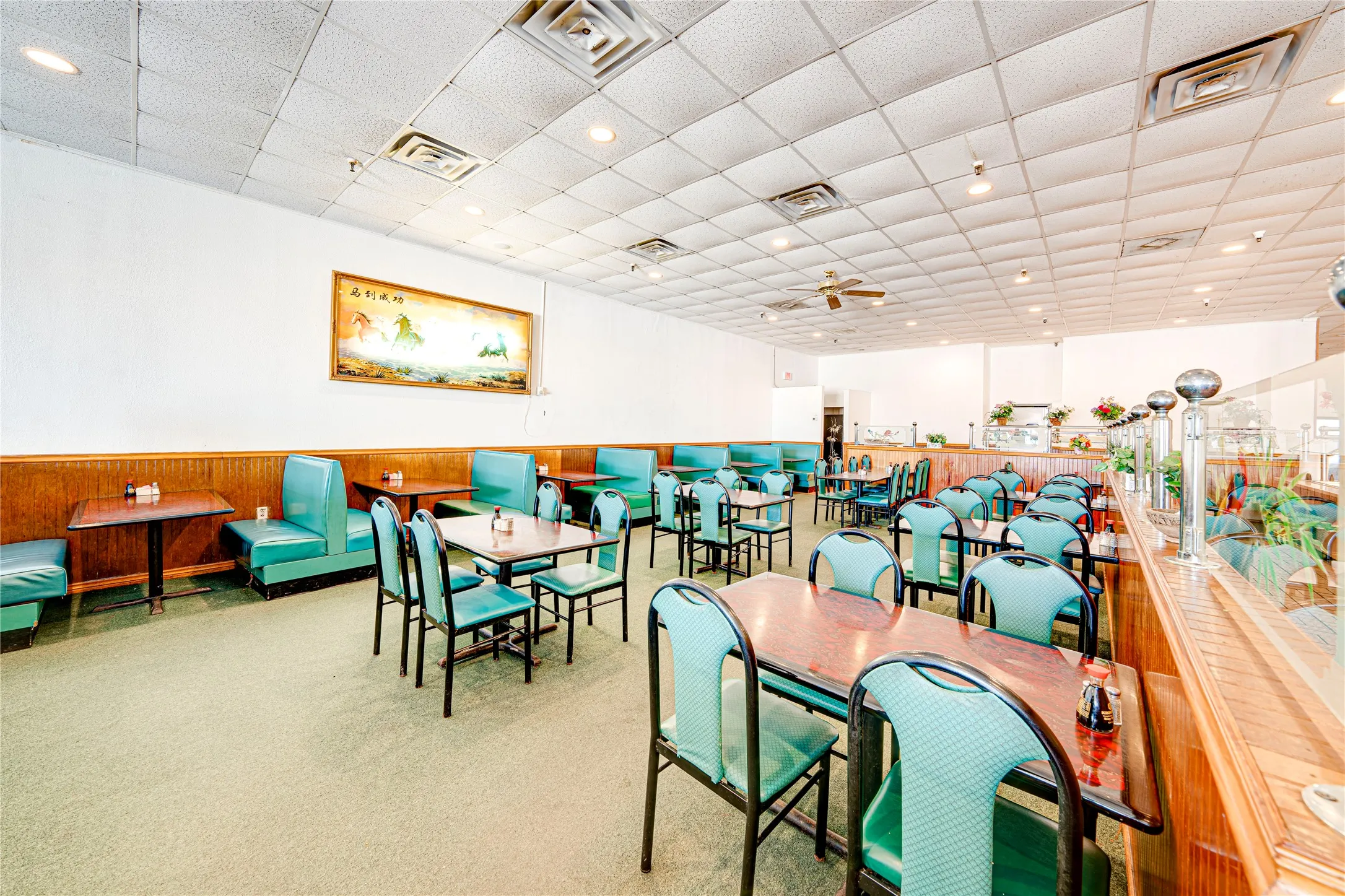 Open dining area with drop ceiling, recessed lighting, and wall-mounted picture