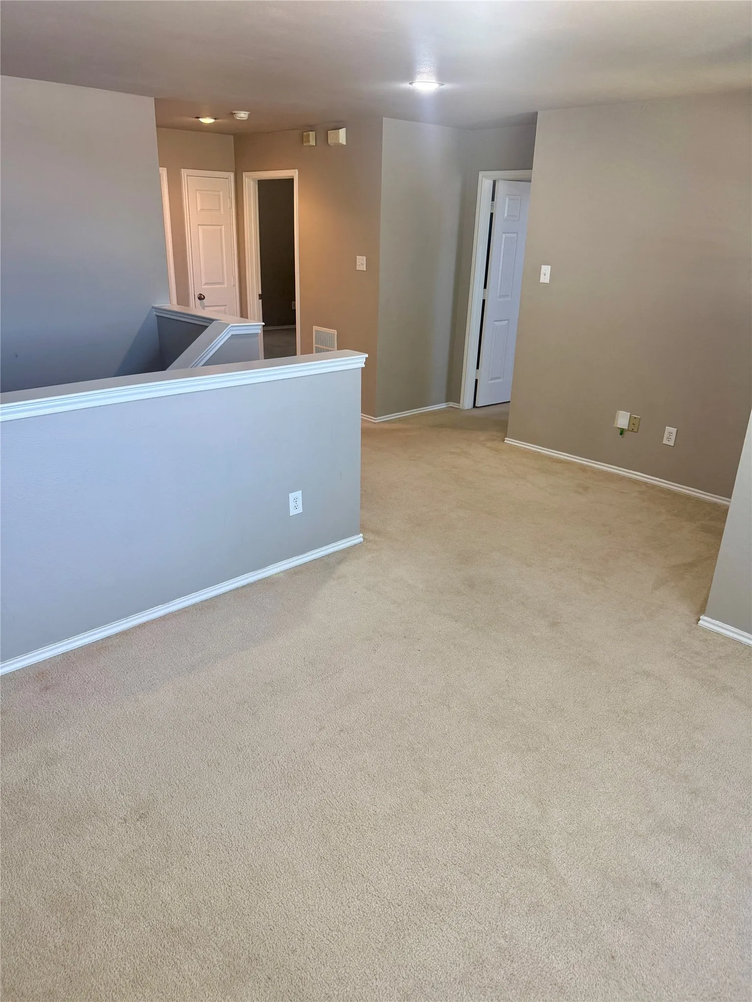Carpeted flooring throughout, neutral wall tones, white trim, and recessed lighting