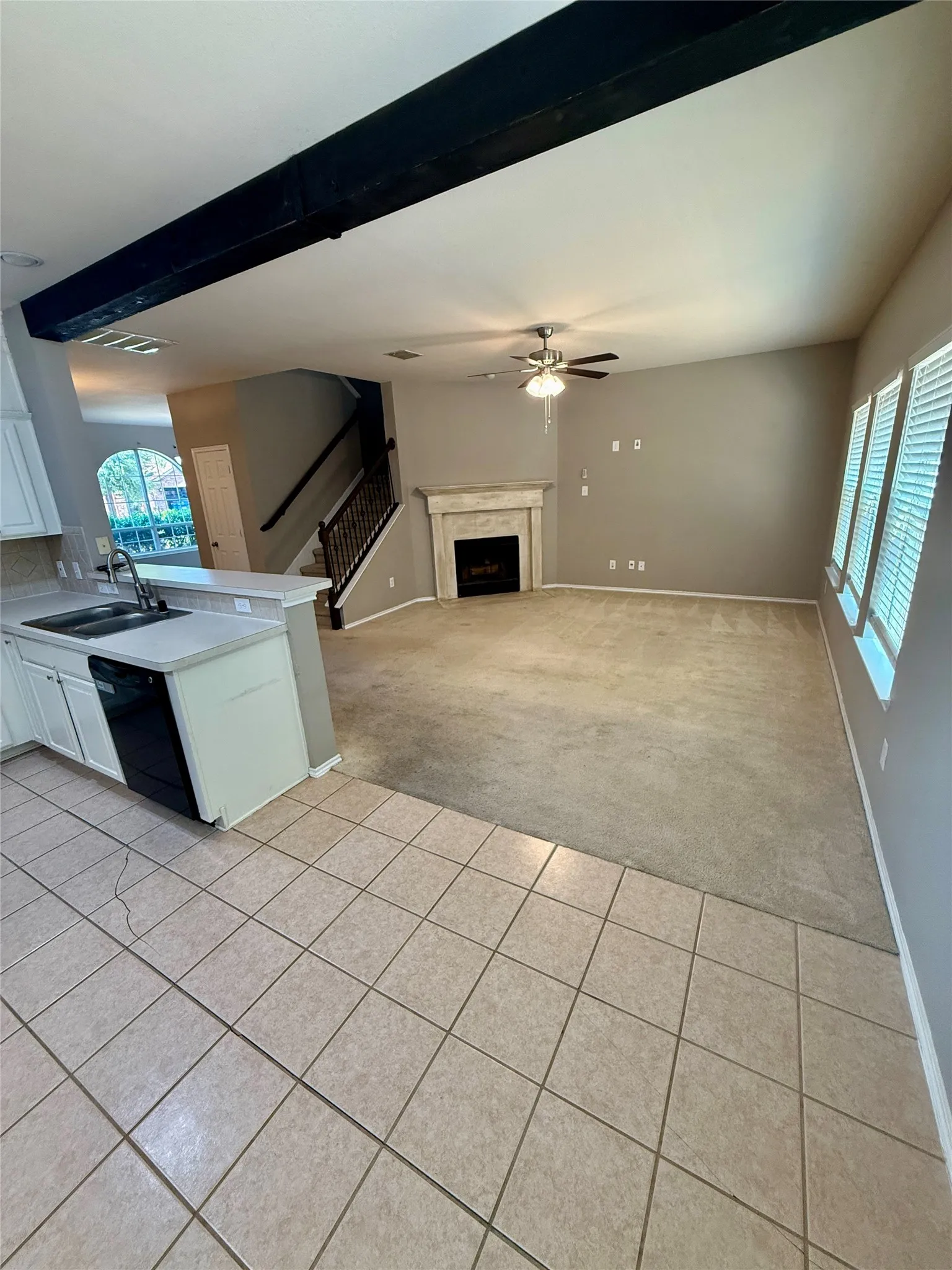 Kitchen featuring a double basin sink, white cabinetry, and tile flooring