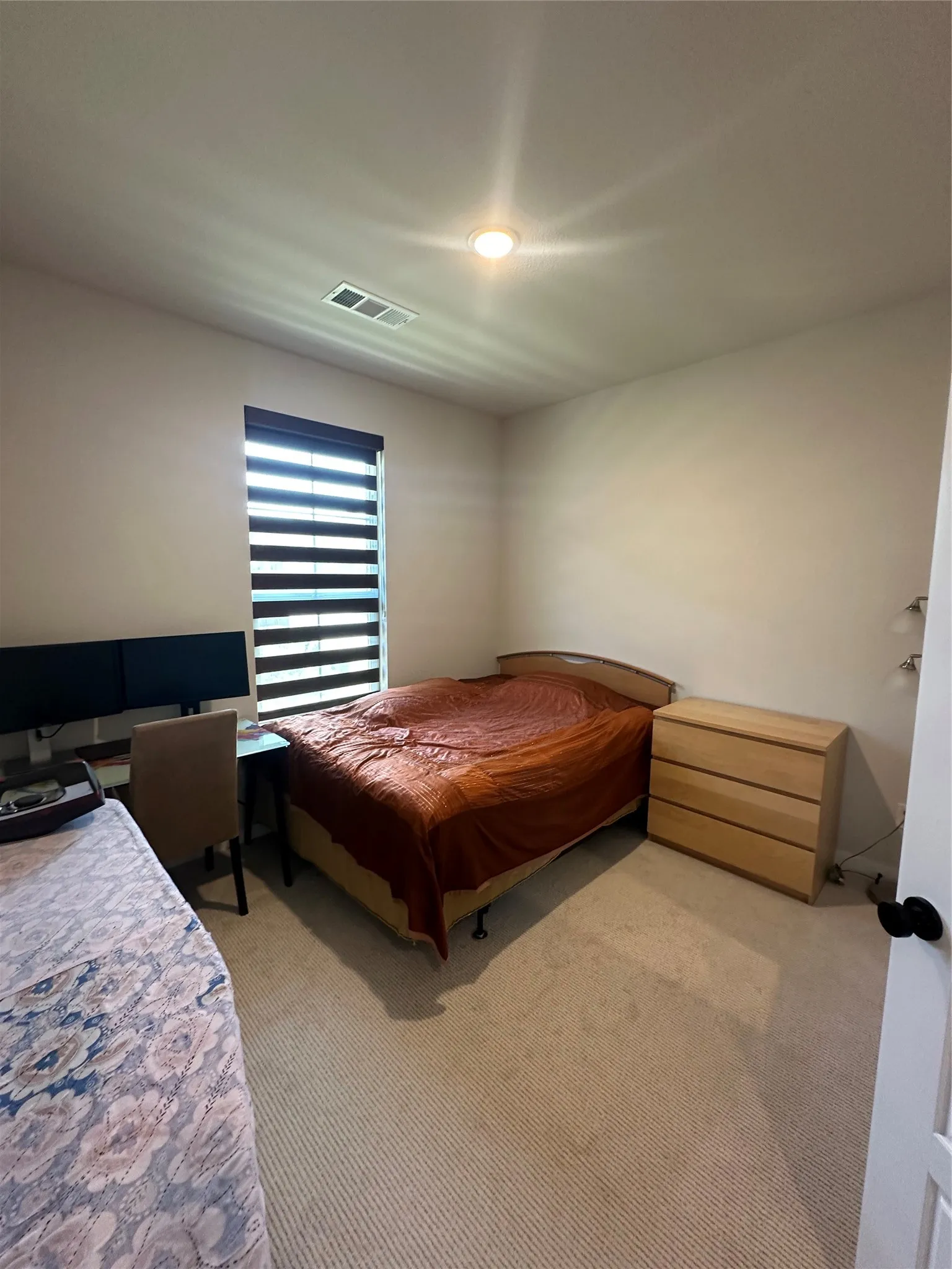 Carpeted flooring with recessed lighting and a window featuring horizontal blinds