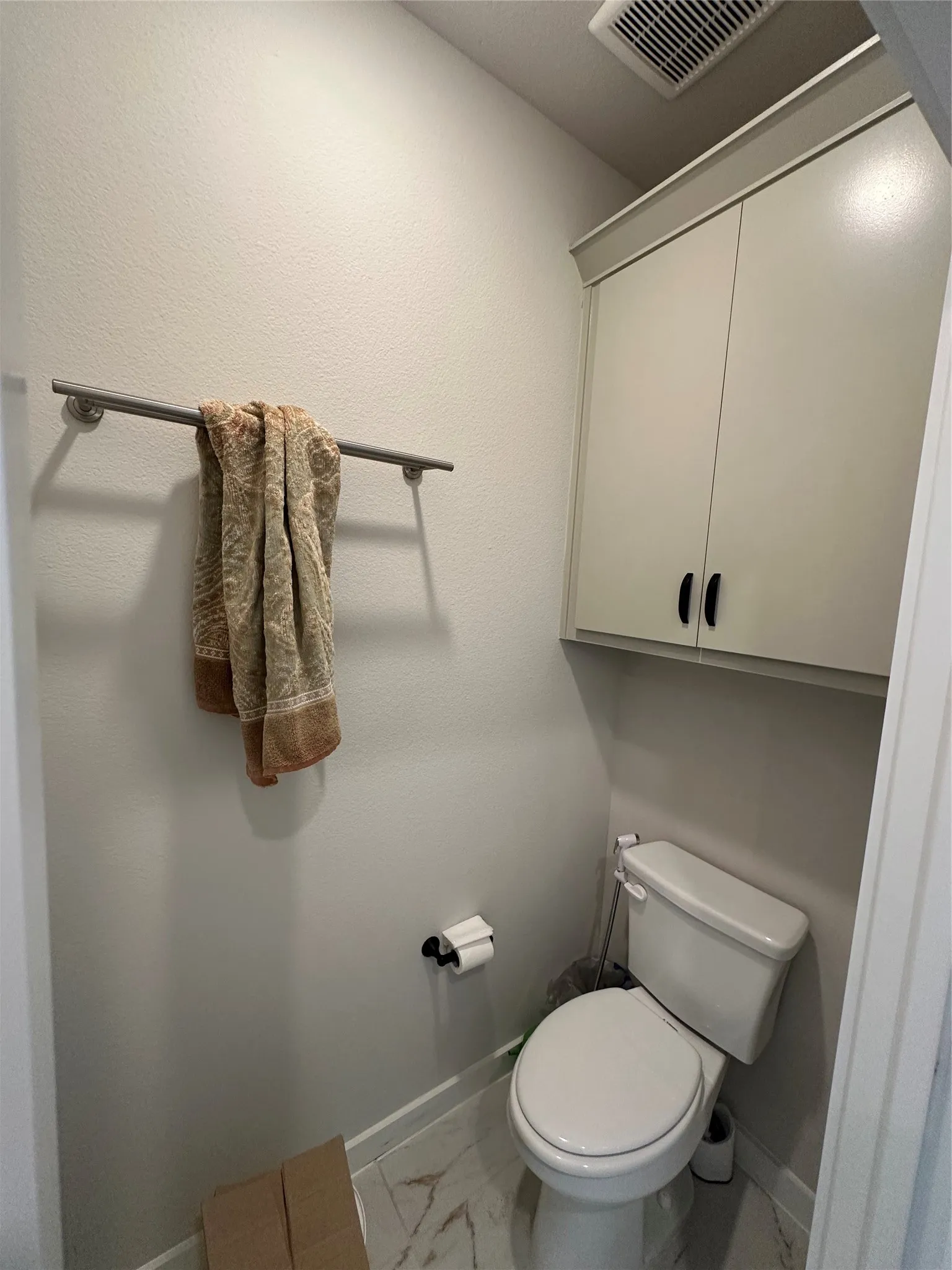 Built-in upper cabinetry, ceiling-mounted ventilation, and tile flooring