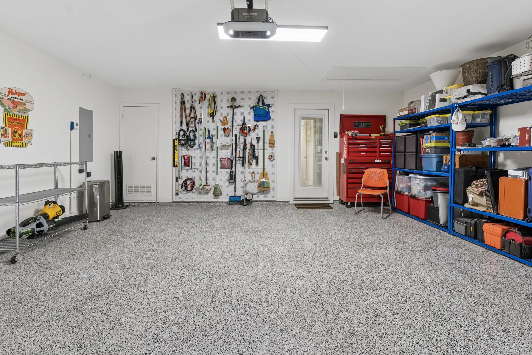 Epoxy floor, pegboard, custom shelving remains.