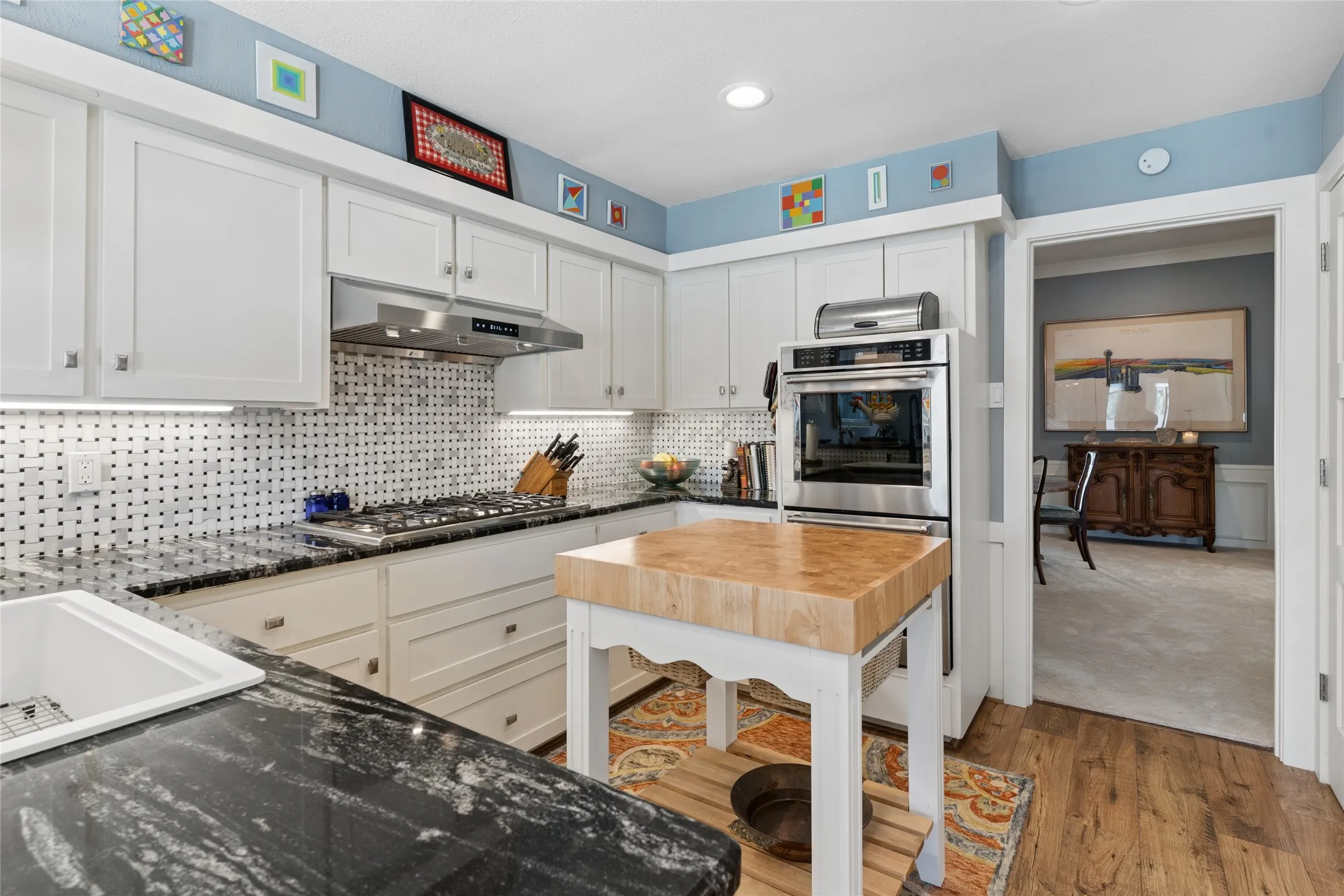 Looking towards dining/great room. Farm style sink, Viking cooktop, and the double KitchenAid convection oven
