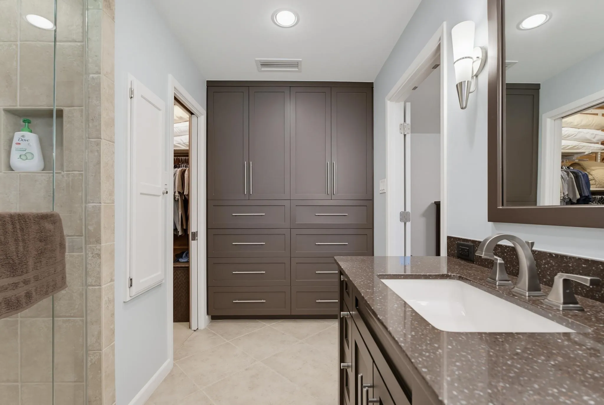 Bathroom vanity with a rectangular undermount sink, a dark countertop, and brushed nickel fixtures