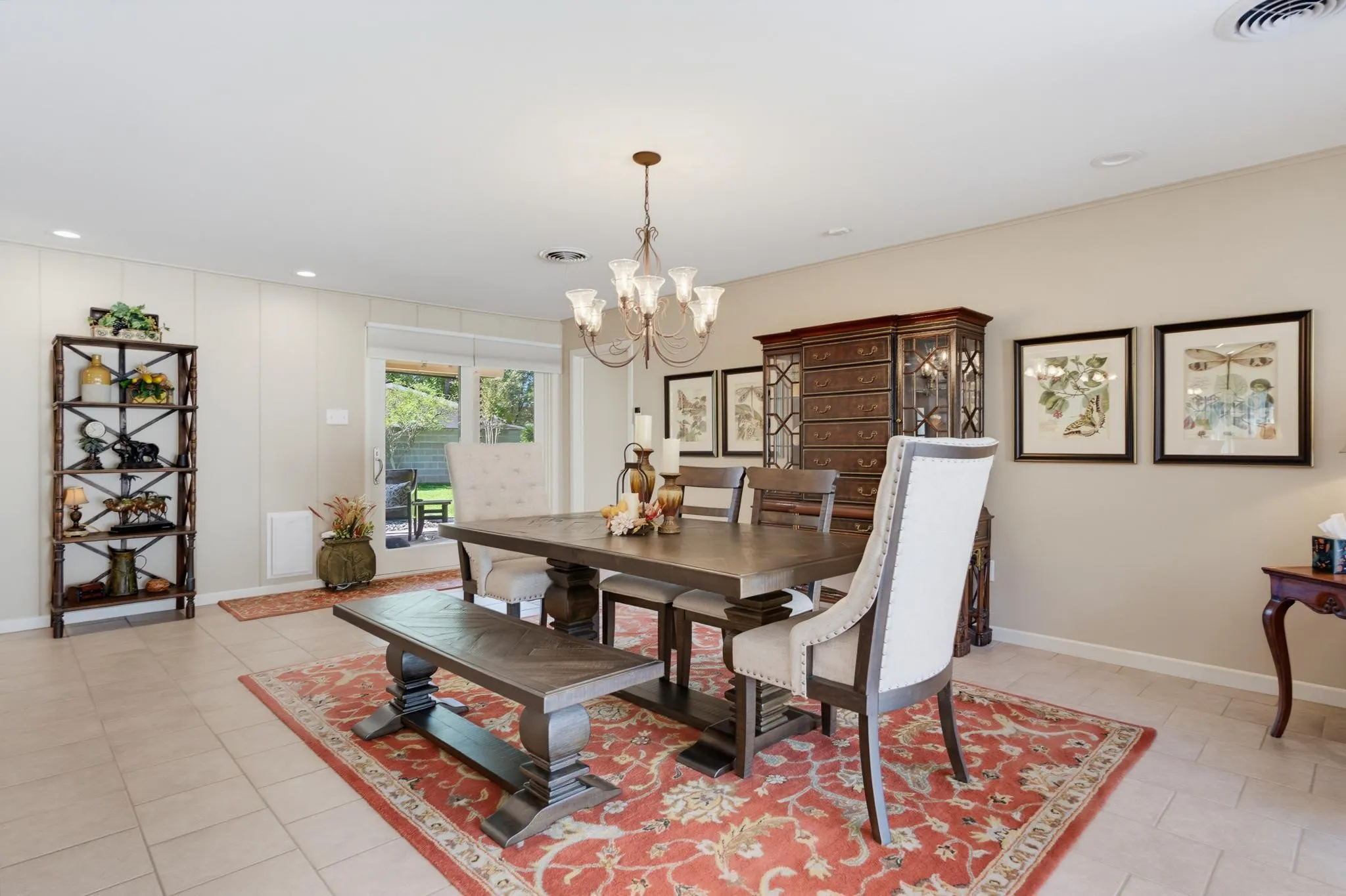 Neutral-toned tile flooring, recessed lighting, and a multi-light chandelier