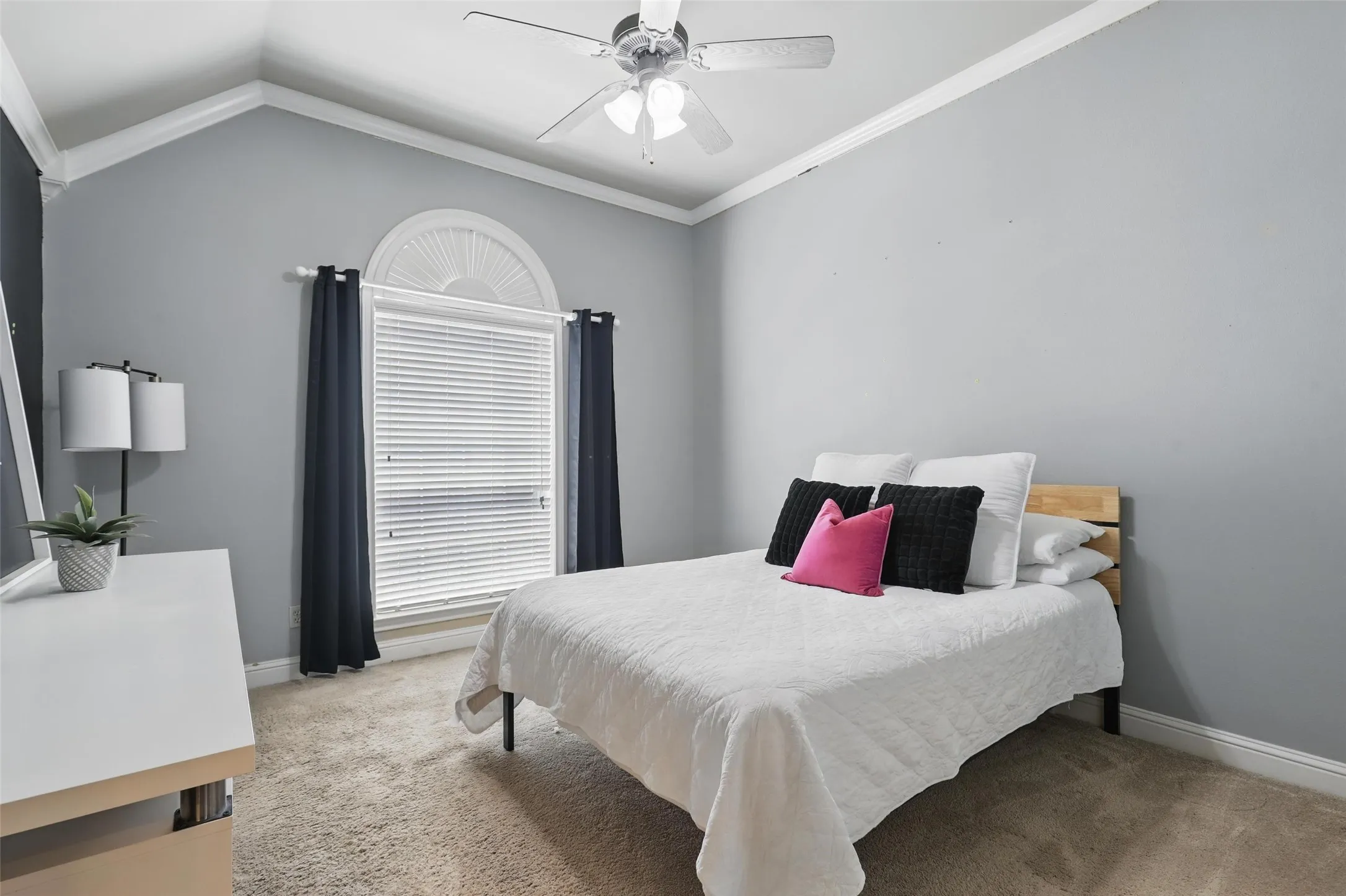 Room featuring vaulted ceilings and a ceiling fan