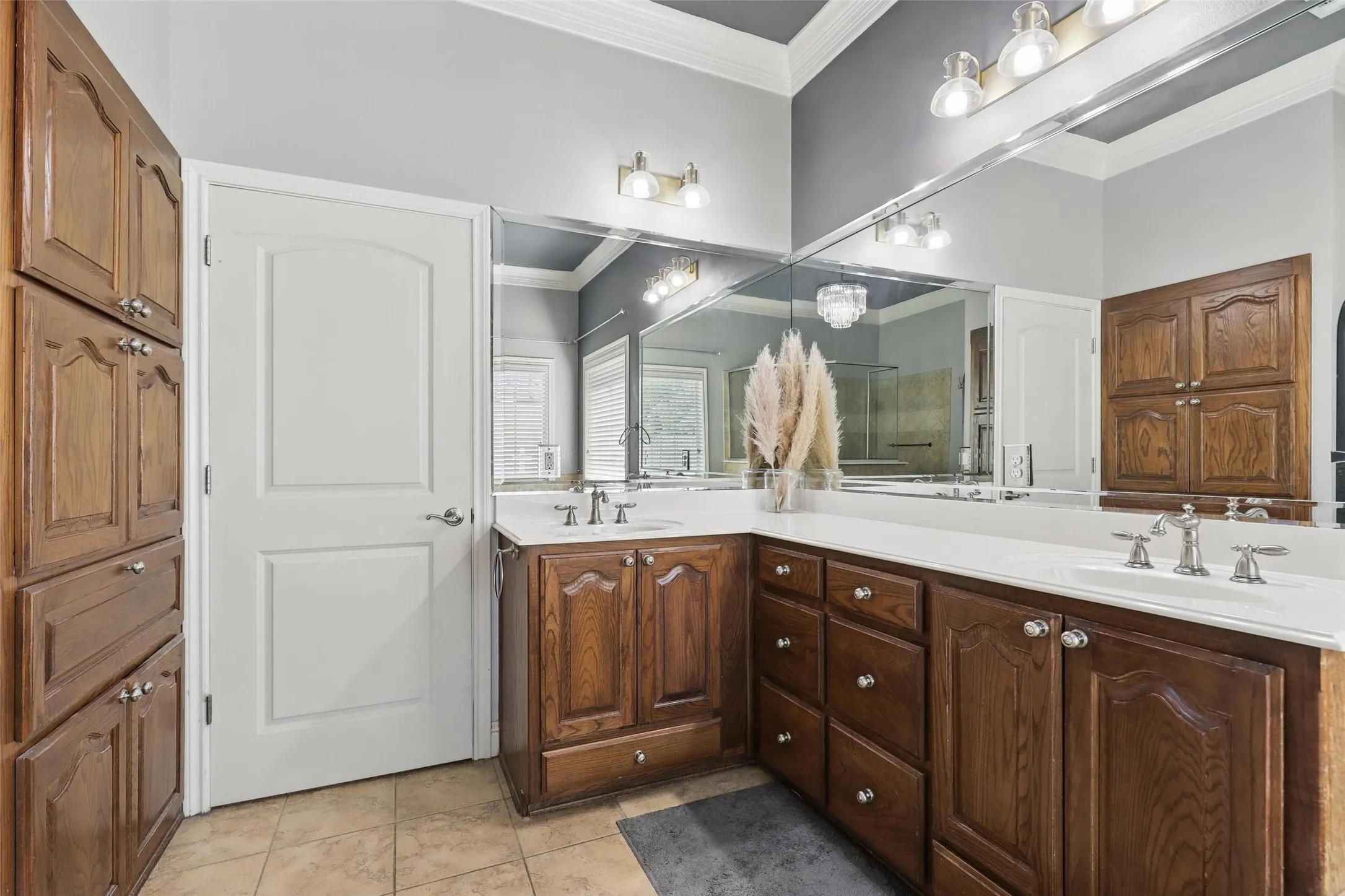 Dual wood-finish vanities with white countertops and undermount sinks