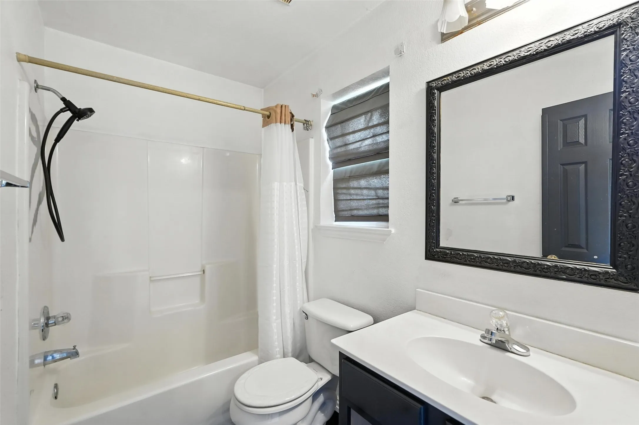 Full bath featuring shower / bath combination with curtain and vanity