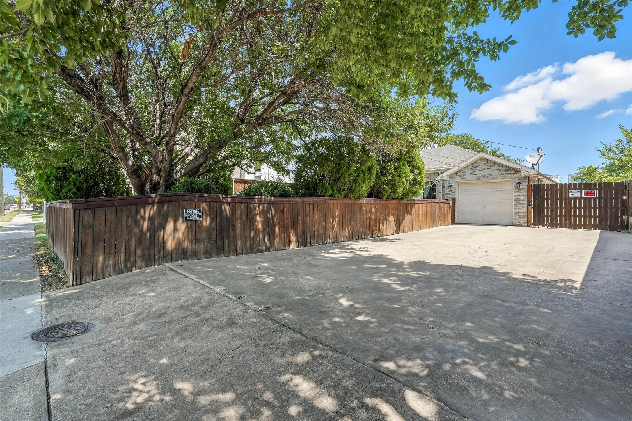 View of patio featuring driveway and an attached garage