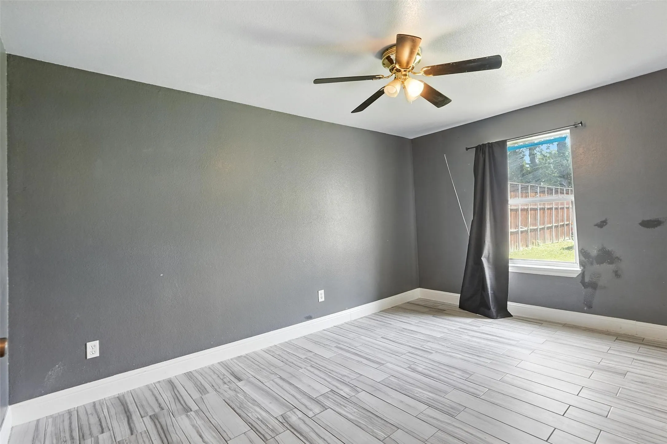 Spare room with light wood-style flooring and ceiling fan