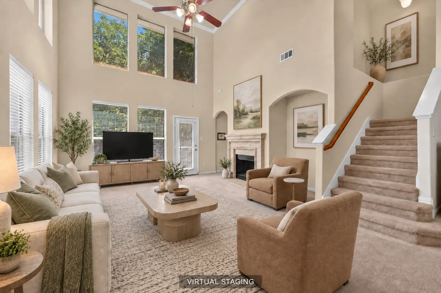 Great living room space with soaring ceilings, abundant natural light, cozy fireplace, decorative niche and upper windows with solar screens.