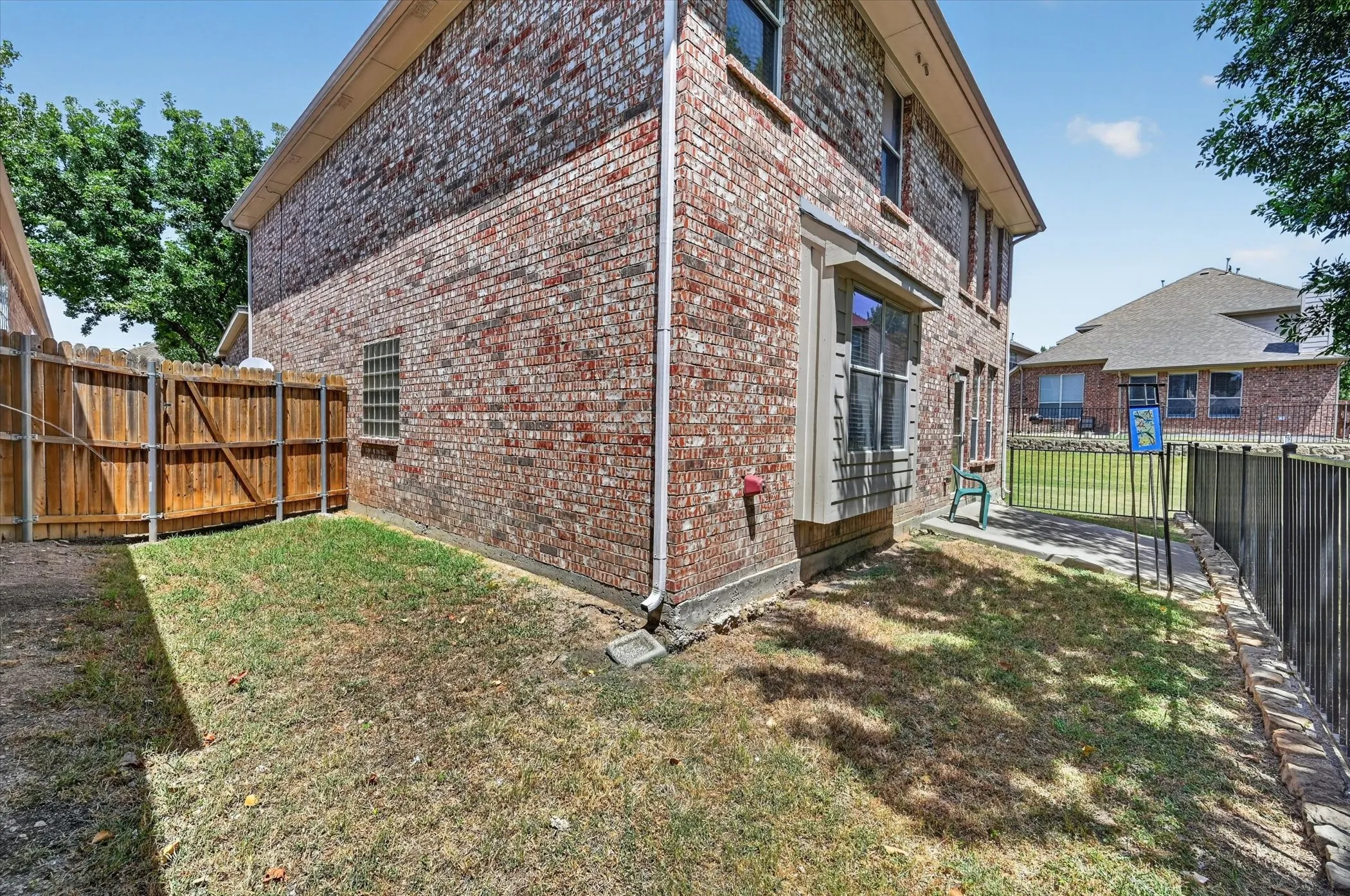 Additional side yard space features a wood privacy fence with gated access.