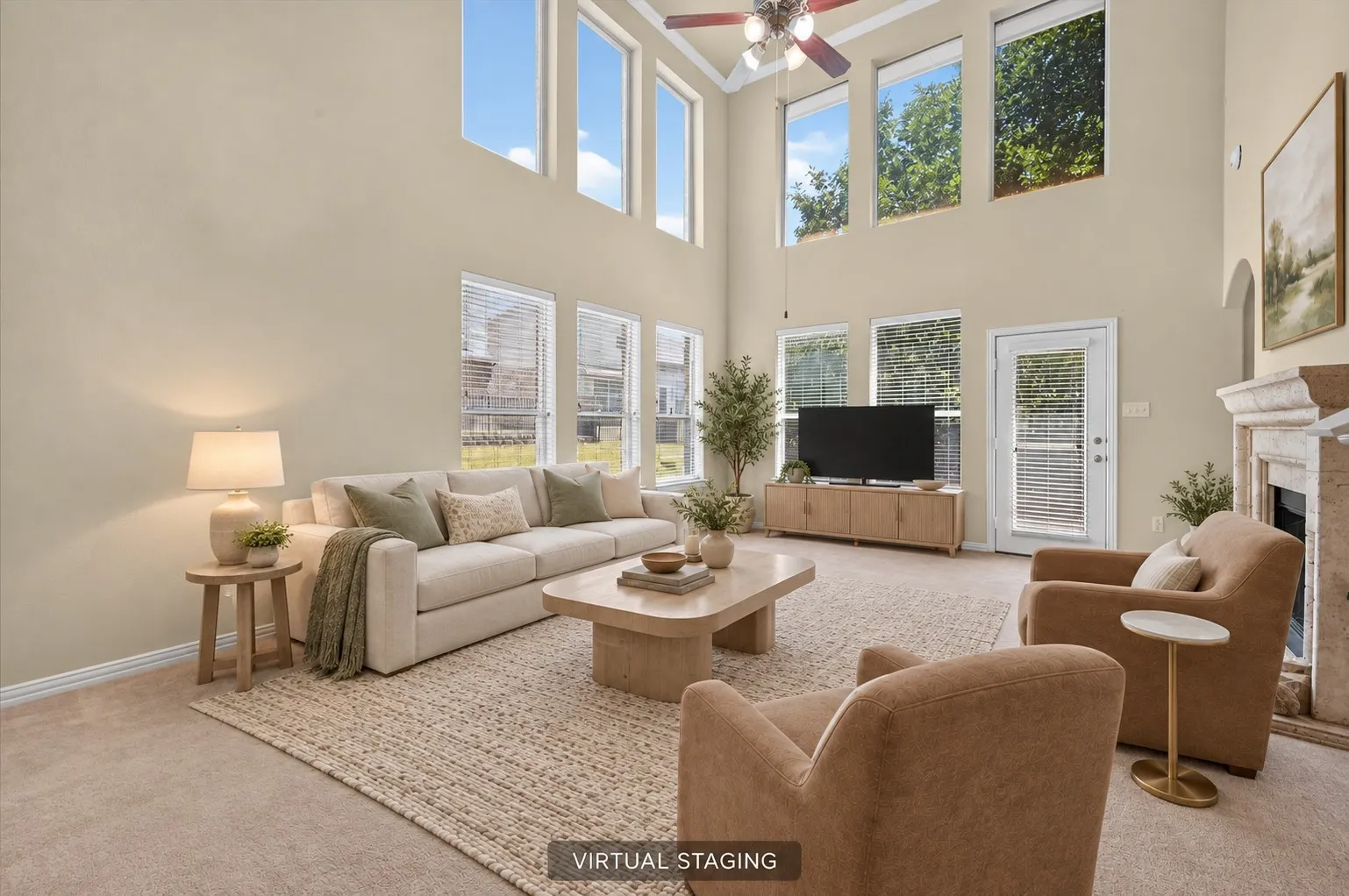 Soaring two-story living room with walls of windows providing abundant natural light.