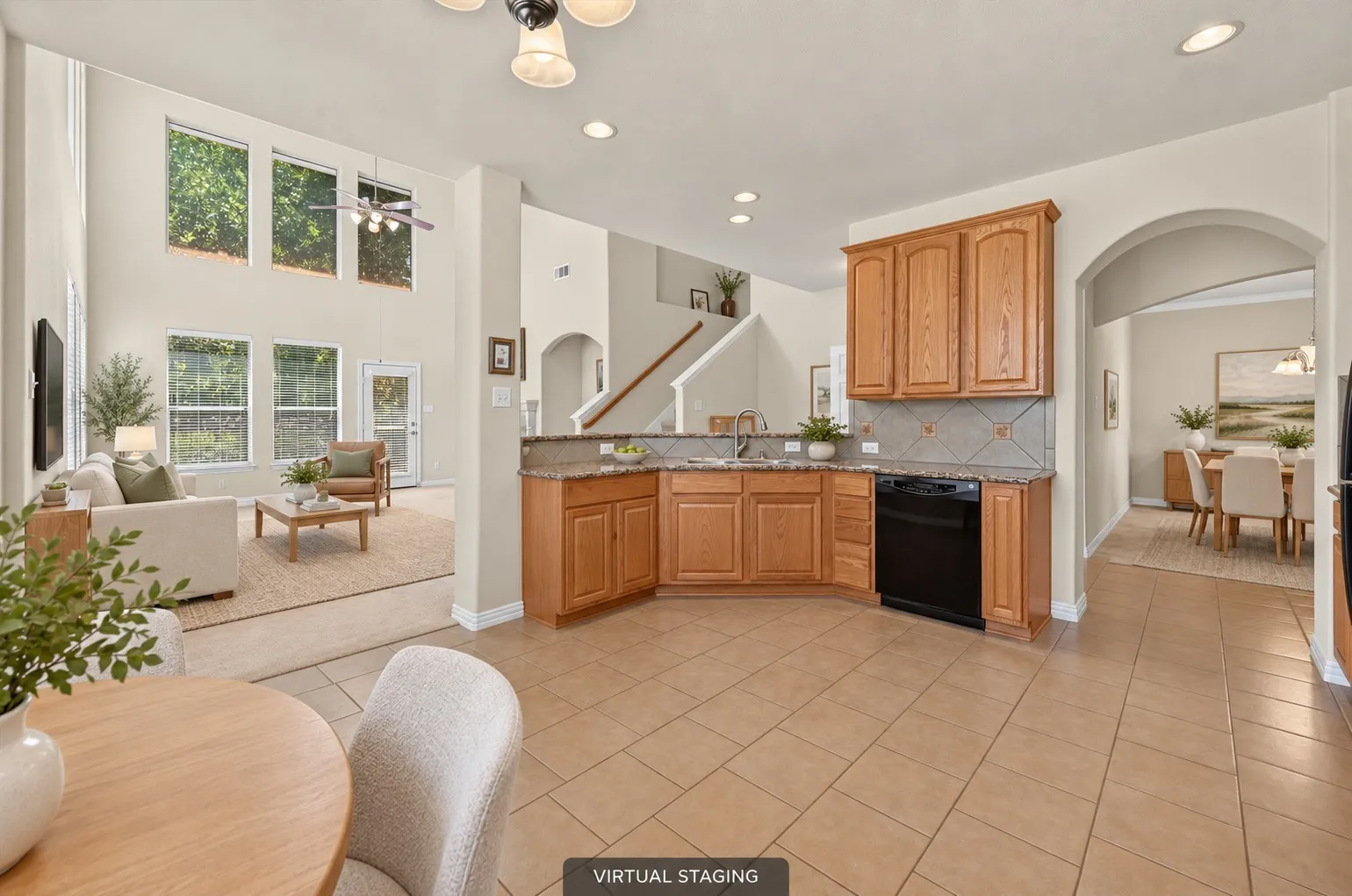 Spacious eat-in kitchen opens to the living & dining areas and features granite countertops, breakfast bar, abundant cabinetry & counter space, plus an oversized walk-in pantry.