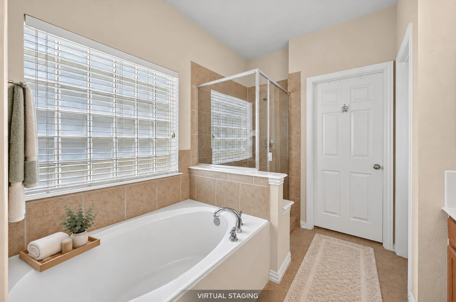 Built-in soaking tub, glass-enclosed shower, tiled flooring, tiled surround, and an opaque window with blinds