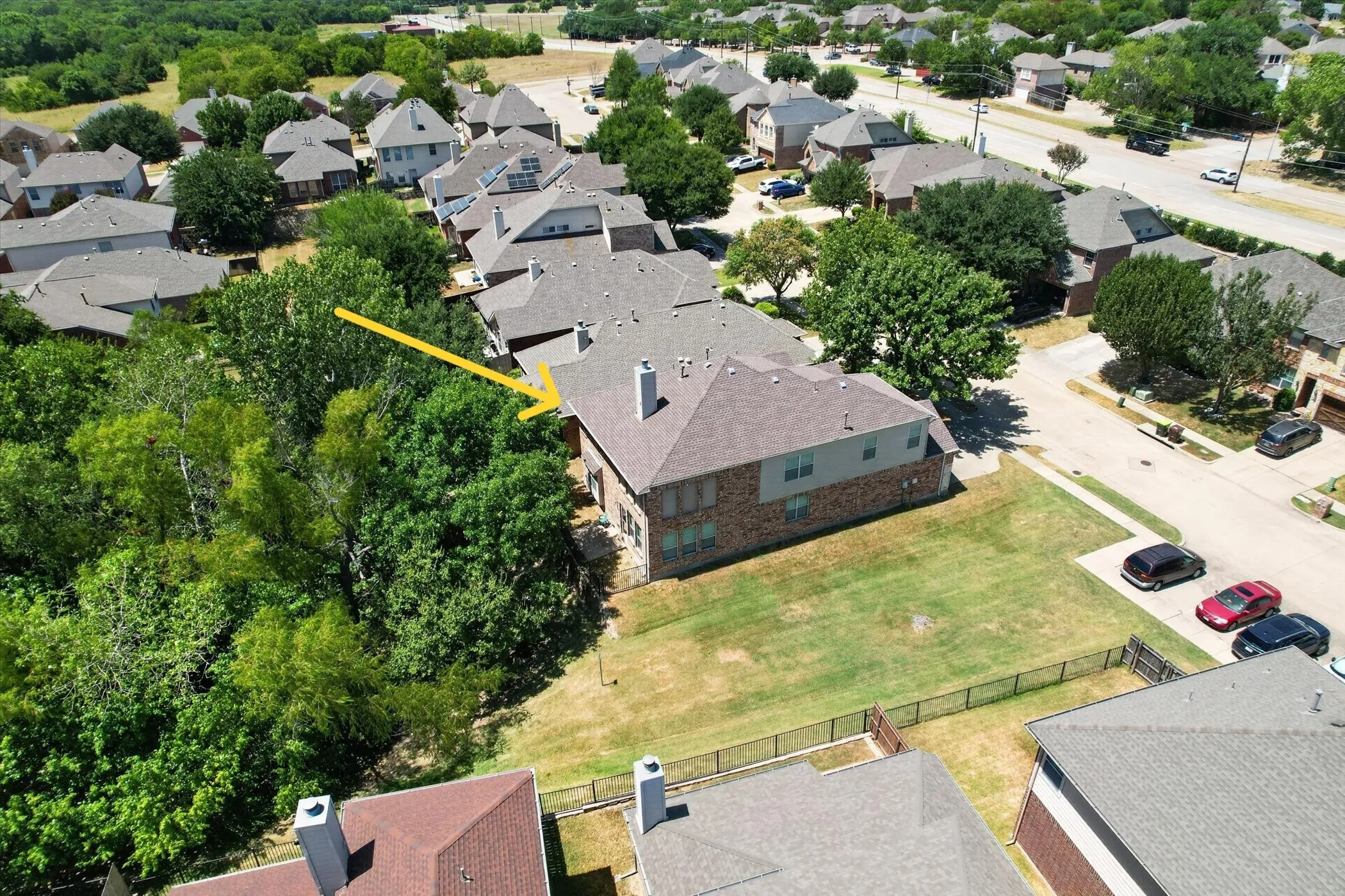 Additional view of the greenbelt areas and convenient open parking near the home.