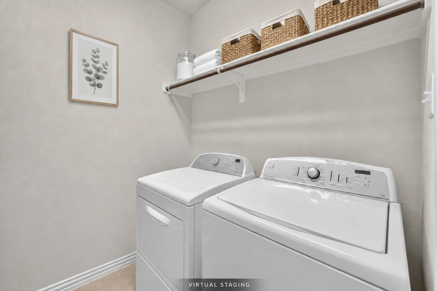 First-floor laundry room conveniently located near the front of the home and features a built-in shelf with hanging rod, plus cabinetry for additional storage.