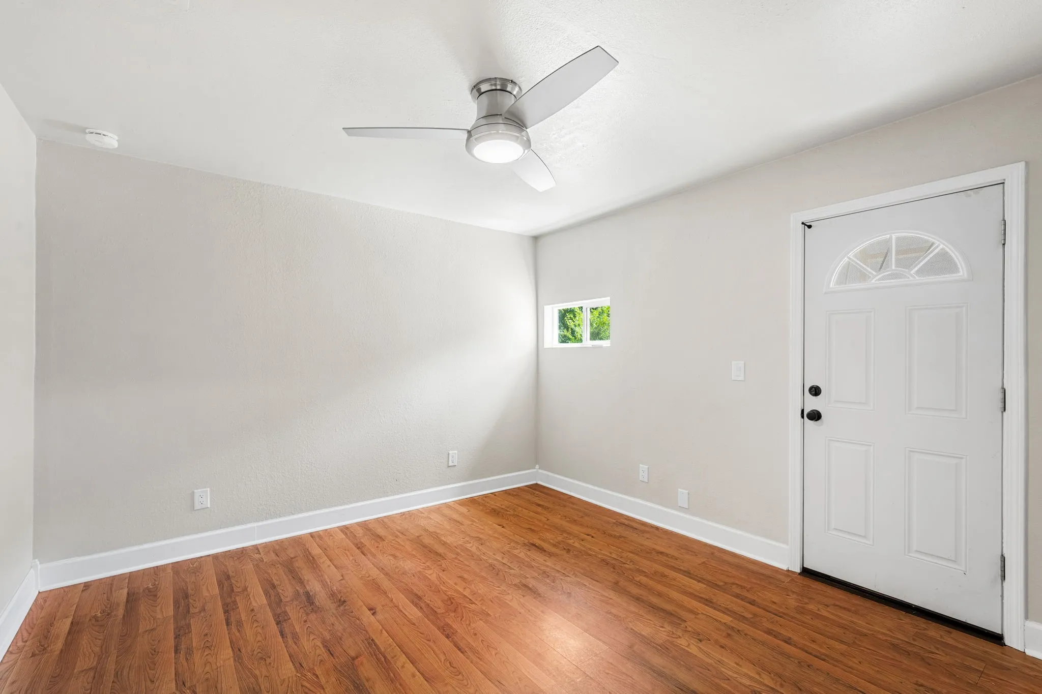 Secondary bedroom with a door to the back