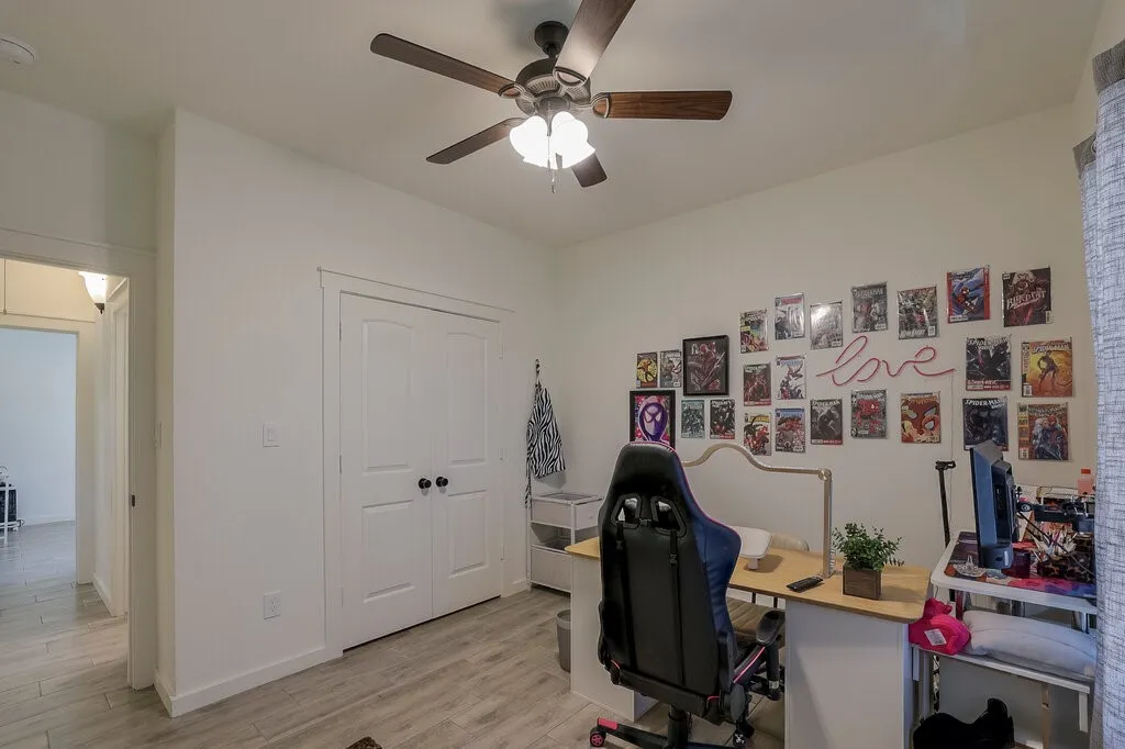 Recessed lighting, wood-finish flooring, ceiling fan, and white interior doors