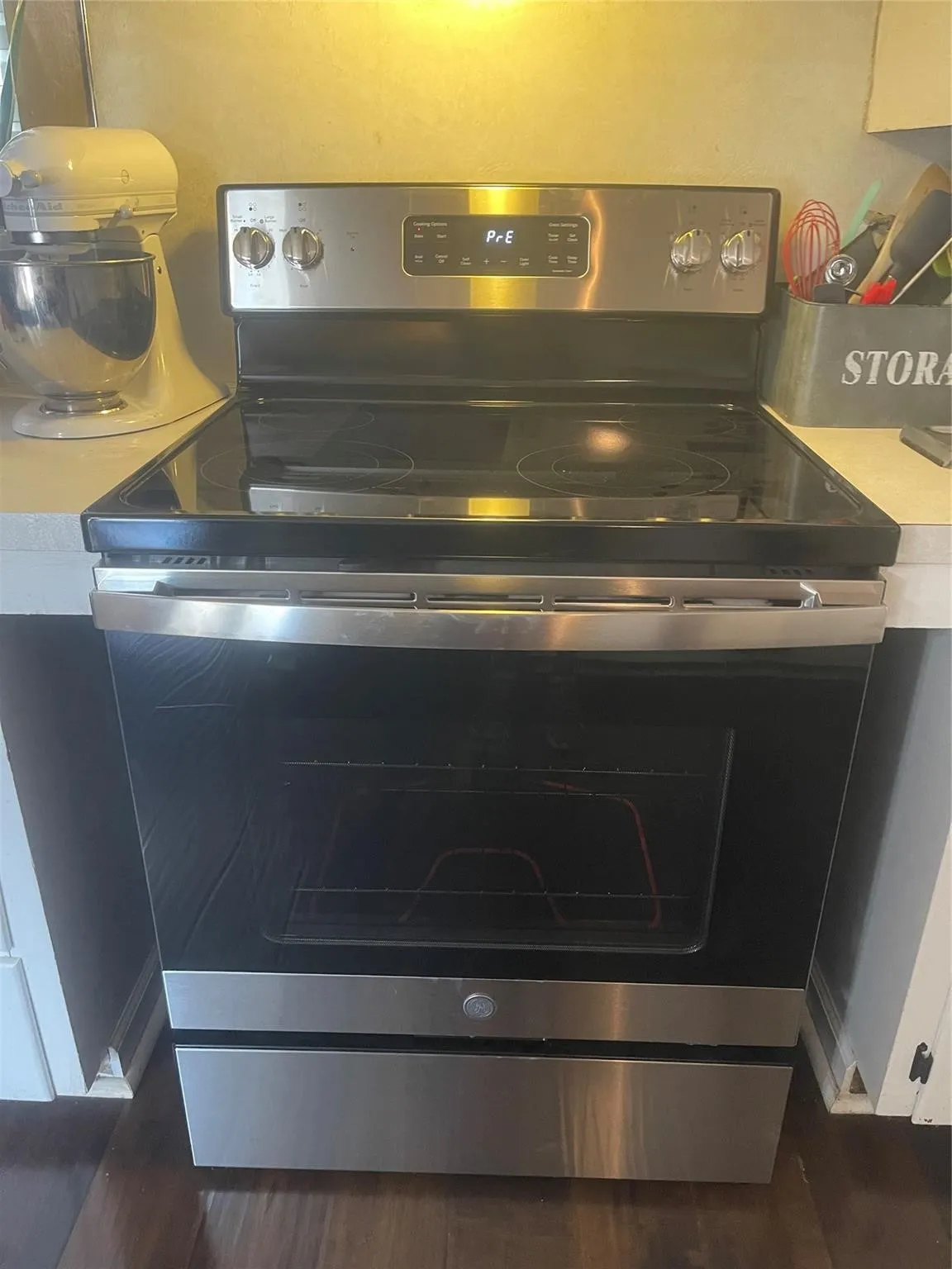Stainless steel range with a glass cooktop and front-facing controls