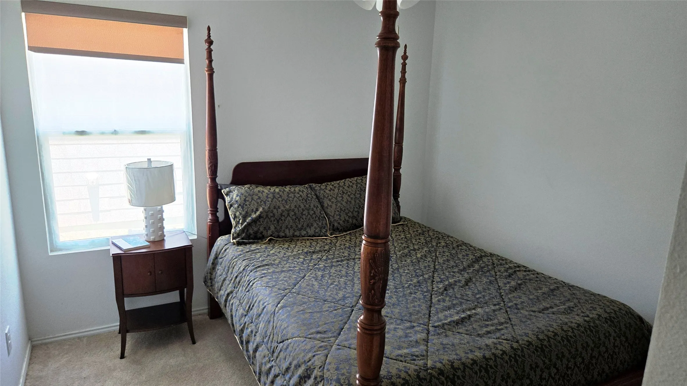 Bedroom featuring light-colored walls and carpeted flooring