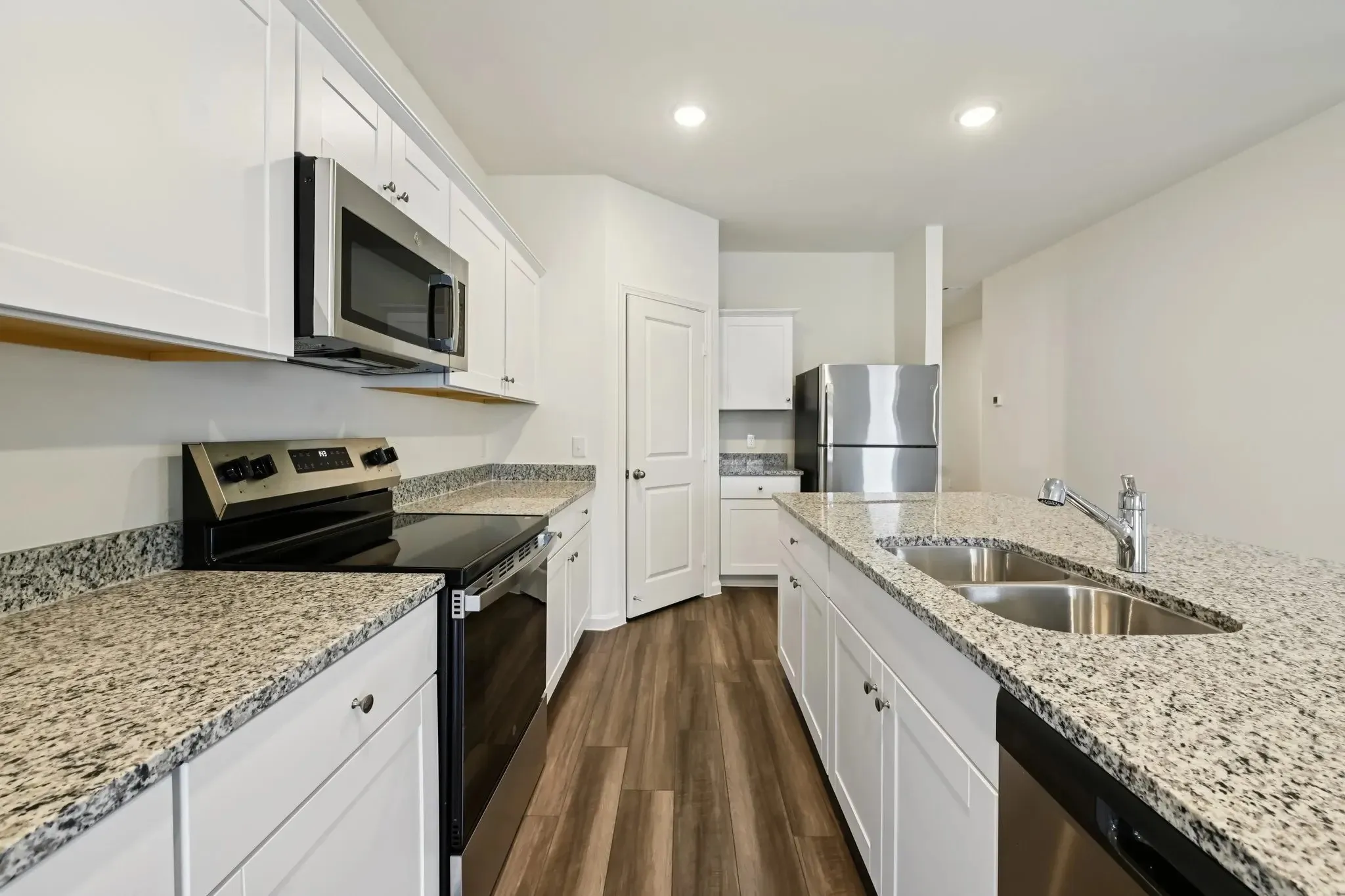 Modern kitchen with white cabinetry and stainless steel appliances